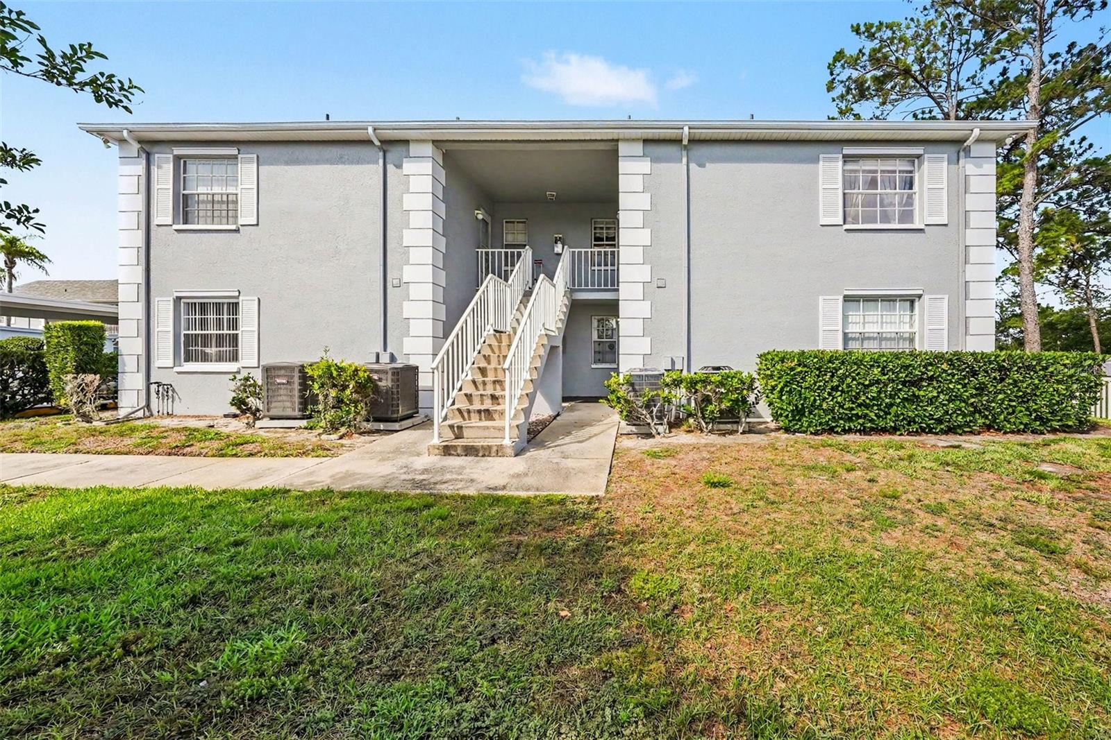 Welcome to Hillside Condos Hudson's Premier 55+ Community! Move right into this charming 2-bedroom, 2 bath second floor condo nestled in the highly sought after Hillside community! This split bedroom layout offers comfort and privacy with an open living and dining area perfect for relaxing or entertaining. The interior shines with recessed lighting that creates a warm, inviting ambiance, and a beautifully appointed bathroom featuring elegant glass shower doors. The screened lanai is perfect for enjoying Florida's gorgeous weather, and covered carport parking with storage is included. The low monthly HOA fee covers basic cable, internet, water, sewer, trash, pest control, pool and all exterior maintenance truly worry-free Florida living! Enjoy the heated swimming pool, shuffleboard courts, and a vibrant clubhouse community. Conveniently located in Hudson just minutes from US-19, you're close to shopping, dining, medical facilities, and the stunning gulf coast. Whether you're a full time resident or seasonal snowbird, this move-in ready gem is an exceptional value. Schedule your private showing today — this one won’t last!