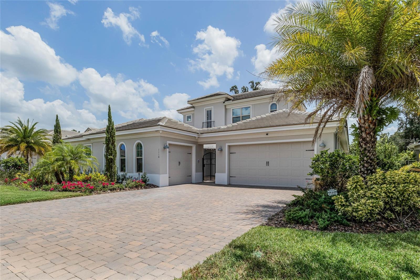 Nestled within the exclusive enclave of Estancia at Windermere, this exceptional custom pool residence offers the perfect blend of sophisticated design, luxury finishes, and timeless Florida living. Built in 2019 and situated on a professionally landscaped homesite, this stunning two-story estate spans over 4,230 square feet of thoughtfully designed living space with 5 bedrooms and 5 bathrooms. The elegant interior showcases soaring ceilings, expansive living spaces, and a bright open-concept floor plan designed for both everyday comfort and grand-scale entertaining. A gourmet chef's kitchen serves as the heart of the home, featuring an oversized center island, premium built-in appliances, wine refrigerator, custom cabinetry, and generous gathering areas. The luxurious first-floor primary suite offers a private retreat with a spacious bedroom, spa-inspired bath, and oversized walk-in closet. Additional highlights include a dedicated office/den, formal dining room, loft-style secondary living area, media/flex space, oversized laundry room, and abundant storage throughout. High ceilings, designer finishes, custom window treatments, and expansive sliding glass doors enhance the home's sophisticated ambiance. Outdoor living is equally impressive. The resort-style backyard was designed for entertaining and relaxation, featuring a covered lanai, brick-paver pool deck, sparkling heated pool, outdoor kitchen, grill station, and a fully fenced private backyard surrounded by mature landscaping. The three-car garage, concrete tile roof, and covered front porch further complement the home's exceptional curb appeal. Located just minutes from charming downtown Windermere, residents enjoy one of Central Florida's most desirable luxury communities known for its tree-lined streets, lakeside setting, upscale estates, highly rated schools, and proximity to world-class golf, dining, shopping, and entertainment. Convenient access to the Butler Chain of Lakes, premier private schools, major highways, and the attractions of the Orlando area make this location as desirable as the home itself. Estancia offers an intimate luxury neighborhood atmosphere with beautifully maintained grounds and estate-sized homesites that provide both privacy and prestige. This extraordinary residence delivers the ultimate Windermere lifestyle—where luxury, comfort, and convenient living come together in one remarkable home.