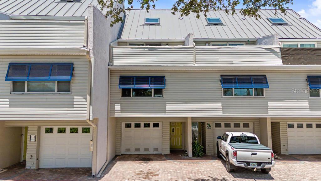 Three level Townhouse with a deeded boat slip.  This Townhome has 3 bedrooms, 2.5 baths, and Bonus Room on the ground floor.  It did not sustain any storm damage or water intrusion from recent hurricanes.  The building is solid concrete with vinyl siding, and metal roof.  The view is over the back yard pool, and bay.  This is the builders own private residence, and owner has added more to the loft, and a Bonus Room on the ground floor, thus adding additional square footage to total 1,989 sq ft of heated area.  The windows are storm rated. New appliances in the kitchen.  Pirates Cove is a sought after location.  Recent UPDATES"  Stove, Microwave, Dishwasher, Washer & Dryer, and Dual Inverted A/C (2025).