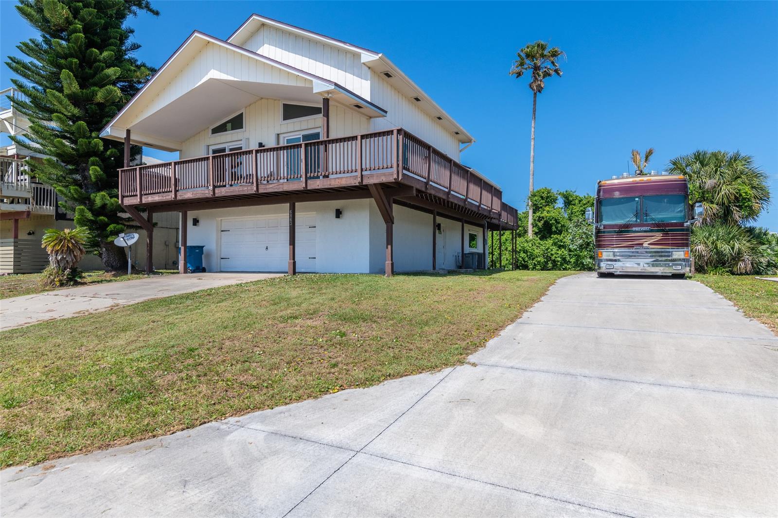 This is not your average Bethune Beach house. Situated on an over-sized 75 ft wide lot located on one of the quietest roads on the barrier island, this remodeled home features incredible river views to the West and ocean views from the rooftop deck. Updates to this home include; new roof(2022), new electrical panel(2022), new downstairs HVAC (2022), all new windows and doors (2018), and new exterior LED lighting (2018). This property includes a new separate driveway (2019) large enough to park your recreational vehicle or boat that has been reinforced for up to 50k pounds with on-site electricity. The first floor of this amazing home features an over-sized 2 car garage and a downstairs living quarters with separate kitchen, living room, bedroom and bathroom. The main living area on the 2nd floor has a fireplace and is very open and great for entertaining. The wrap around balcony boasts gorgeous river views and is large enough to hold multiple different seating areas. There is a 3rd floor loft which can be used for any number of things and features even more storage space with two over-sized closets. Both kitchens and all three bathrooms have been recently updated with high end appliances, fixtures and counter-tops. Enjoy the rocket launches, ocean waves and expansive river sunset views from the rooftop deck. Located less than half a mile to Canaveral Seashore Park this location is ideal if you want tranquility and that beach lifestyle. Includes parcel; 850501510490 ;Water: City