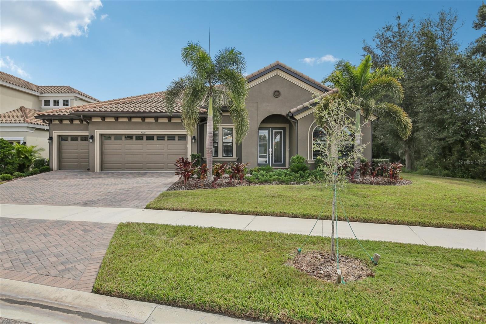 Stunning Pool Home in Gated Hawkstone Artisan. Step into a beautifully upgraded home that shows like a model—complete with a sparkling pool and spa. This is a rare chance to own a nearly new pool home in the gated Hawkstone Artisan community, prized for its top-rated Newsome High School and Barrington Middle zoning. The Key Largo I, an award-winning single-story floor plan, blends comfort, style, and practicality—perfect for entertaining, hosting family gatherings, working from home, and more. Soaring 12-foot ceilings in the foyer, formal dining room, grand room, and kitchen create a dramatic sense of space and light in this open-concept layout. The home features our “Coastal Grey” Design Collection Interior: sleek Sonoma Grey cabinetry, Calacatta Novello quartz countertops, elegant wood-look tile flooring throughout, and numerous other high-end finishes. The home comes with plantation shutters throughout, gutters with leaf filter system and upgraded landscaping. The luxurious owner’s retreat offers double-door entry, two walk-in closets, a dressing area, and a generous spa-inspired bath. You’ll also find spacious secondary bedrooms, a versatile bonus room, an oversized laundry area, and an expansive covered lanai leading to the sparkling pool and spa—ideal for relaxing or entertaining outdoors. Hawkstone, a sought-after master-planned community in Lithia, FL, combines resort-style amenities with proximity to top-rated schools, nature preserves, family-friendly activities, US-301, and I-75. Outdoor enthusiasts will love the 969-acre Triple Creek Nature Preserve just two miles south, and the Triple Creek BMX Park a mile away.