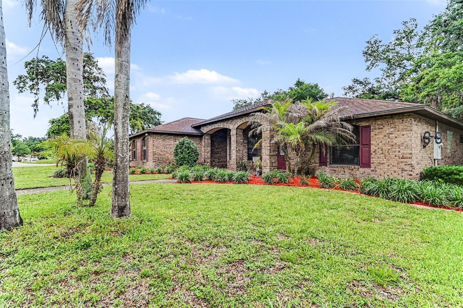 Welcome home to this beautifully maintained custom brick residence in one of Port Orange's most desirable neighborhoods. Designed for both comfort and flexibility, this spacious split-bedroom floor plan offers over 2,100 square feet of living space, including a versatile flex room with French doors that is perfect for a home office, guest room, hobby space, or fitness studio. Vaulted ceilings and abundant natural light create an open, airy feel throughout the main living areas, while the updated kitchen features granite countertops, beautiful cabinetry, and a welcoming breakfast area for casual mornings at home. The private primary suite offers a relaxing retreat with a tray ceiling, bay window, dual walk-in closets, and a spacious bath. Step outside to the covered screened lanai overlooking mature landscaping and a beautifully maintained yard. With a side-entry garage, corner lot location, custom features, and pride of ownership throughout, this home delivers the space, quality, and lifestyle today's buyers are searching for.