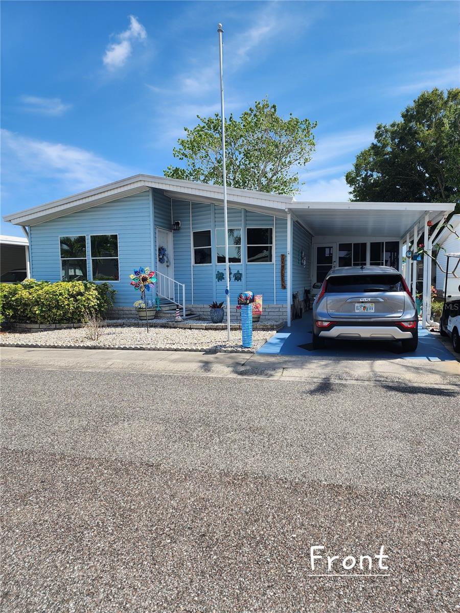 Just move in!  Home is offered 'fully furnished', with all appliances, window coverings, Yamaha electric golf cart & an EV charger mounted in the carport.  The owners have loved and cared for this home for 10 years but are ready for a new adventure.  Improvements include replacement windows, AC w/new ductwork, home has been re-piped.  There is an entry into the living room & entry into the raised lanai which has an AC unit, windows/screens and a new ceramic floor.  The living room and dining room are ample in size, also with laminate flooring.  The master bedroom contains a walk-in closet & ensuite bathroom.  The second bath is across from the guest bedroom.  Located in a premier 55+ community; Co-Op fees include WATER/SWR, GARBAGE P/U 2xWK, POSTAL DELIVERY TO YOUR DOOR, WKLY YARD MAINTENANCE & SPECTRUM CABLE/INTERNET & STREAMING SERVICES.
