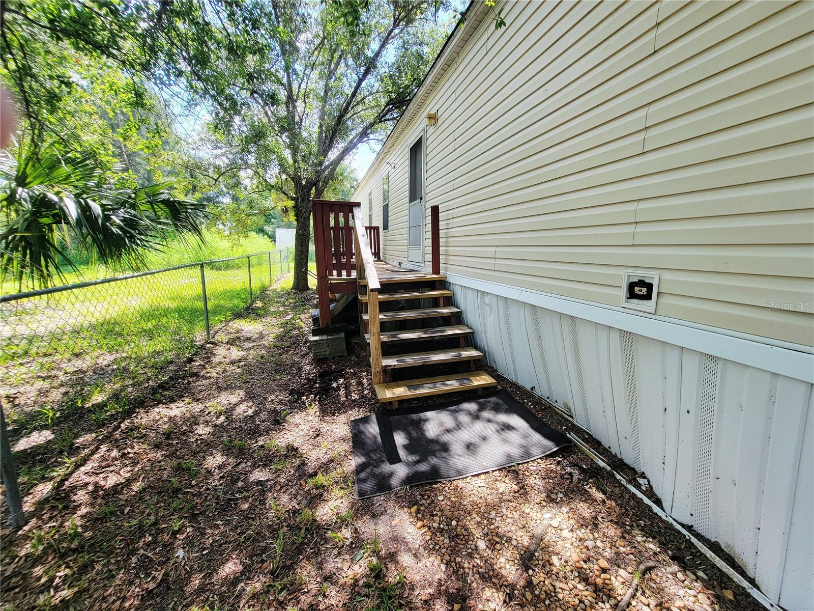 Affordable opportunity! This 2-bedroom,2-bath single-wide mobile home offers 728 square feet of open living space and sits on its own lot-NO LOT RENT! Freshly painted inside, the home is ready for its next owner and offers plenty of potential with just a little TLC. Enjoy the spacious yard, complete with a fire pit that's perfect for relaxing evenings or entertaining family and friends. A separate fenced dog run provides a safe space for pets to play. Whether you're looking for a primary residence, seasonal getaway, or investment property, this home offers excellent value and the benefits of land ownership. Conveniently located near shopping, dining, and everyday amenities. Bring your personal touches and make this property your own!
