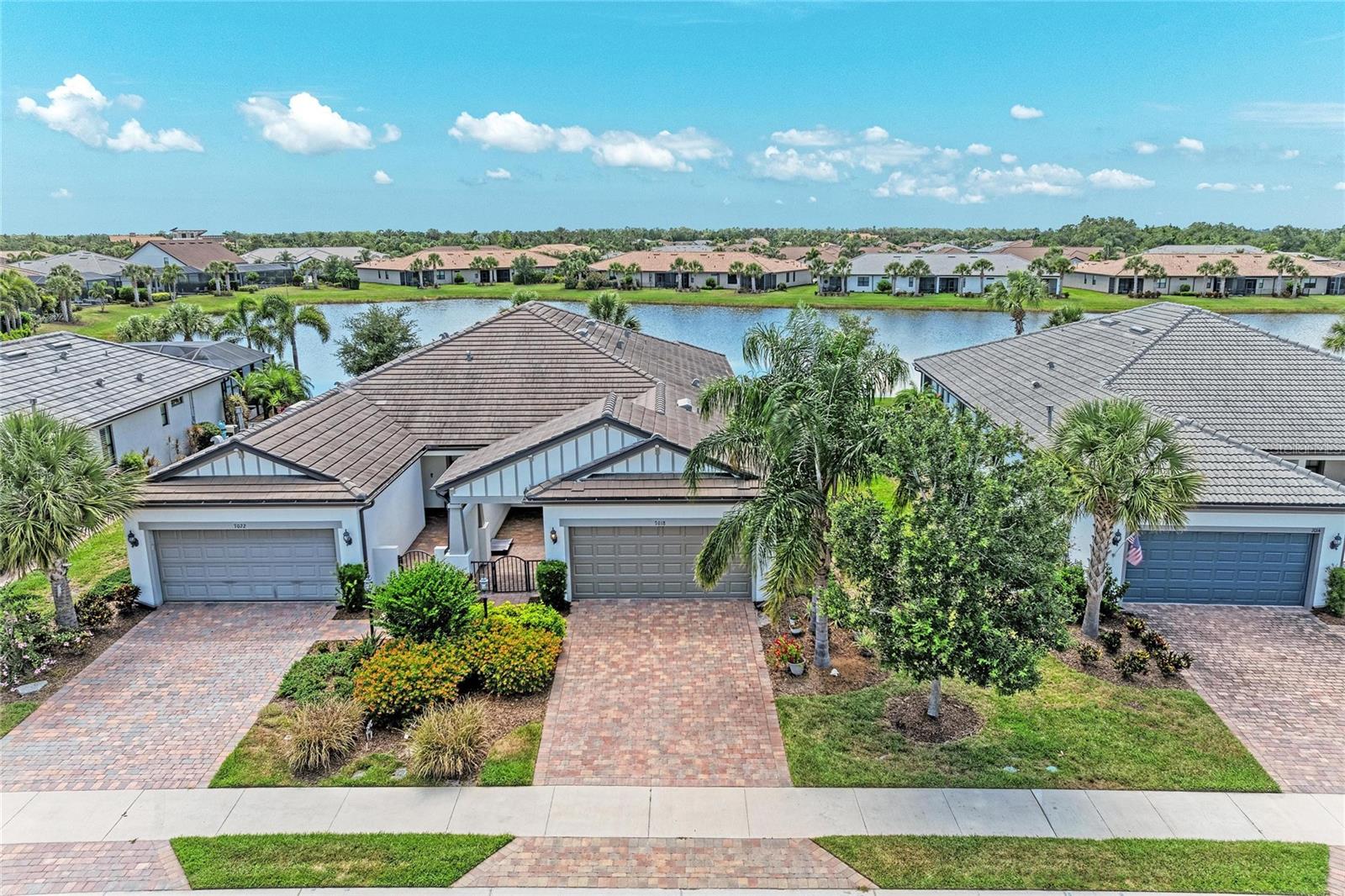 Located in the highly sought-after 55+ community of Del Webb Lakewood Ranch, this meticulously maintained PulteGroup attached villa offers peaceful waterfront living with the perfect blend of luxury, comfort, and low-maintenance convenience.

This light-filled home features an open-concept floorplan with split bedrooms, offering 2 bedrooms plus a den and dedicated office space — ideal for flexible living, entertaining, or working from home. The gourmet kitchen is beautifully appointed with soft-close cabinetry and drawers, pull-out shelving, abundant prep and storage space, and a large center island with seating.

Enjoy tranquil waterfront views from the expansive screened lanai, while the fenced backyard and professionally landscaped front and side yards create inviting outdoor spaces to relax and unwind. Additional highlights include an attached 2-car garage and bright, airy living spaces throughout.

Residents of Del Webb Lakewood Ranch enjoy exceptional resort-style amenities including a clubhouse, fitness center, heated resort pool, lap pool, satellite pool, 6 tennis courts, 8 pickleball courts, bocce ball courts, walking trails, dog parks, craft room, billiards room, library, WiFi café, full-time lifestyle director, firepit and covered fireplace gathering area, plus on-site dining at Cheers Café. A vibrant social calendar with dozens of clubs, events, and activities makes it easy to enjoy the active Florida lifestyle.

Conveniently located near shopping, grocery stores, restaurants at Lakewood Ranch Main Street, golf courses, and just a short drive to world-renowned Gulf Coast beaches including Siesta Key, Lido Beach, Anna Maria Island, and St. Petersburg. Situated within one of the nation’s top-ranked master-planned communities, this exceptional waterfront villa offers an outstanding lifestyle opportunity in desirable Lakewood Ranch.

Come experience this beautiful waterfront home today — it will not last long!