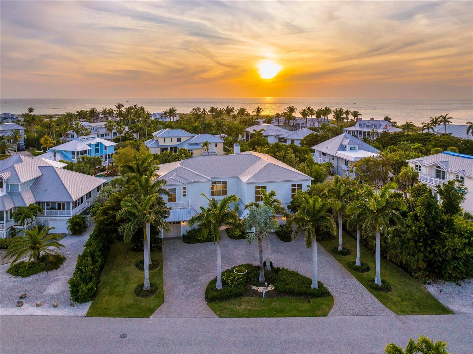 One or more photo(s) has been virtually staged. This beautiful custom-designed home has convenient private beach access. Located on Gasparilla Island, this modern home has all the amenities you could want. High-end finishes abound, including a gourmet kitchen with marble countertops, a new Sub-Zero refrigerator and Wolf gas cooktop range hood, and a double oven. Enjoy views of the surrounding Florida landscape from the breakfast nook and living area with the large windows. While you may never want to leave the gorgeous main kitchen, there’s an outdoor kitchen with a pizza oven right by the pool. The primary ensuite bathroom overlooks the pool and has a luxurious new bathroom, soaking tub, walk-in shower, and spacious walk-in closet. The other bedrooms are on the opposite side of the home for privacy. Whether you want to take a dip in the pool, relax by the fire pit, shoot basketball on your private half-court, or stroll down to the beach, this lovely property is the perfect Florida home base.