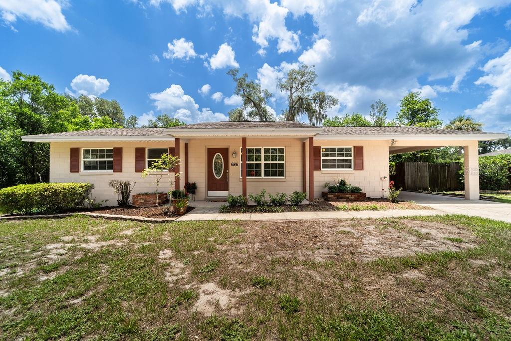 Virtually Staged. Adorable Move-in ready 3 bedroom 2 bathroom home! This charming home features fresh interior and exterior paint, new wood-look laminate flooring throughout, and new landscaping that creates outstanding curb appeal. Step inside to a bright, inviting interior with a clean, modern feel and low-maintenance finishes. The spacious yard offers plenty of room to relax, entertain, or personalize to your needs. Conveniently located just minutes from historic downtown DeLand, Stetson University, shopping, dining, parks, schools, and major roadways, this home offers the perfect combination of comfort, style, and convenience. Whether you're a first-time homebuyer, looking to downsize, or searching for an investment property, this turnkey home is a must-see. Schedule your private showing today!