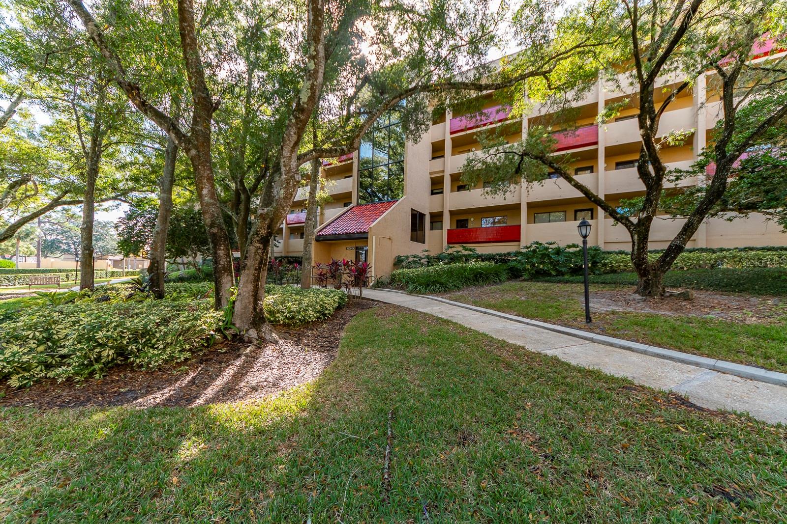 Location! Location! This 1 bedroom 1 bath condo in a 55+ community has under building parking, lobby entrance and 2 building elevators. Nearly every convenience you can imagine right across the street- Publix grocery store, restaurants, banks, hair salons, drugstores and more.  Eat in kitchen has a wall pantry and lots of additional storage. Living room dining room combination opens up to a bright sunroom which can be closed off  with french doors. The sunroom could make a nice sitting area or office space.  The park like grounds are treed, and have a walking path around the entire property. Lovely clubhouse with workout area, and meeting rooms where activities take place; like holiday parties, bingo, card playing and more! Large heated pool to enjoy swimming or doing water exercises and a hot tub nearby for you to relax in. There is also an outdoor grill area for cookouts.  Imperial Pines has a lot to offer.