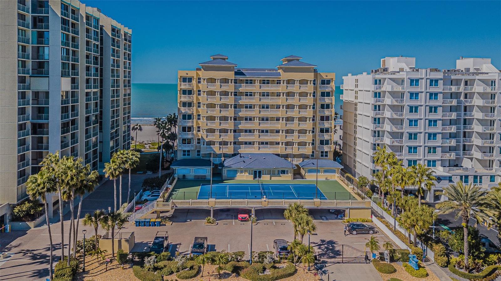 BEACH LIVING AT ITS FINEST! Luxury Sand Key condo, located on the 7th floor of the gated Bella Rosa community, offers breathtaking views of the crystal-clear waters of the Gulf of Mexico and Clearwater Bay’s Intracoastal Waterway. Enjoy peace of mind with a secured entrance and elevator access to a semi-private lobby.
Enter through beautiful double doors into a grand foyer that opens to a spacious, open floor plan filled with abundant natural light from expansive windows throughout the day. Take in stunning Gulf views from the living and dining areas, or step out onto the extended balcony featuring newly installed hurricane privacy shutters—perfect for enjoying unforgettable sunsets.
The private master suite boasts gorgeous water views, balcony access through sliding glass doors, two walk-in closets, and an opulent en-suite bath with a garden tub, dual vanities, a walk-in shower, and a private water closet. Tile flooring runs throughout the condo, adding to its elegant coastal feel.
Both guest bedrooms enjoys views of the Intracoastal Waterway and a shared balcony. The large chef’s kitchen is ideal for entertaining, complete with ample cabinetry, a large center island, breakfast bar, separate service bar, quarts  countertops, and newly installed stainless steel appliances.
Bella Rosa offers residents a resort-style, amenity-rich environment with direct private beach access, a heated pool and spa, poolside entertaining area with gas BBQ grills, tennis courts, pickle ball a fitness center,  hurricane privacy shutters.
A designated parking space is conveniently located next to the lobby entrance. Designer furniture & furnishings are negotiable, offering buyers the opportunity to acquire a beautifully curated, move-in-ready coastal residence. This highly desirable unit is just waiting for new owners to enjoy spectacular evening sunsets and their own piece of paradise.