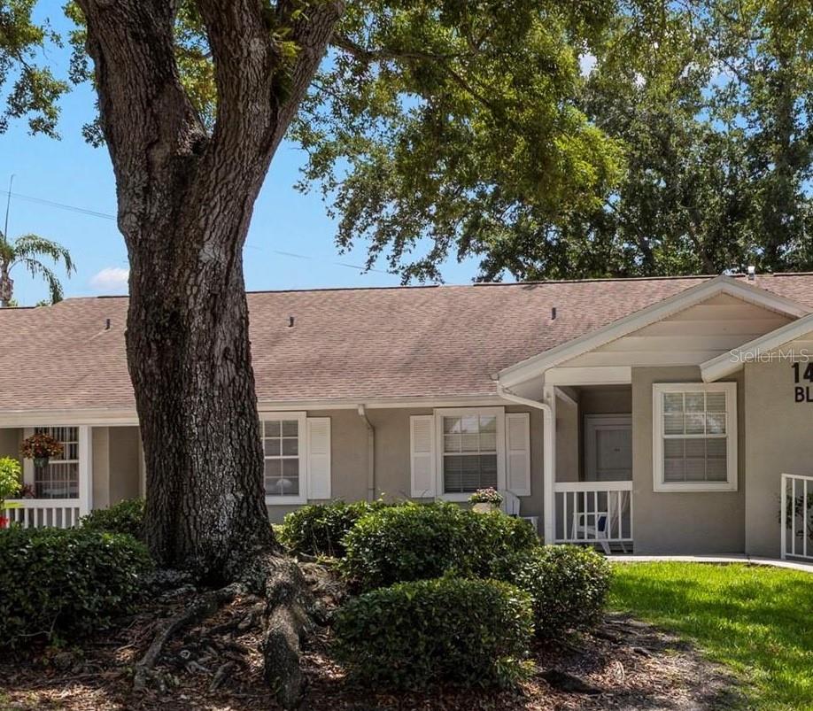 Virtually Staged. Tucked within a beautifully maintained community, this updated 2-bedroom, 2-bath end-unit villa offers comfort, convenience, and carefree Florida living at its finest. Your monthly HOA fee includes sewer, water, trash, cable, internet, grounds and exterior maintenance, plus reserves—making everyday living as effortless as it is enjoyable. Step inside to discover an inviting open-concept layout highlighted by soaring vaulted ceilings and abundant natural light. The updated kitchen is both stylish and functional, featuring soft-close cabinetry, gleaming granite countertops, decorative tile backsplash, a built-in pantry closet, breakfast bar seating, and space for a casual dining table. The kitchen flows seamlessly into the spacious great room, creating the perfect setting for entertaining or relaxing at home. Just beyond the living area, pocket sliding glass doors open to a versatile bonus room with exterior access—ideal for a home office, reading retreat, hobby space, or additional sitting area. The private primary suite is tucked toward the rear of the home and features a large walk-in closet and an en-suite bath with a step-in shower. The secondary bedroom also boasts a generous walk-in closet and is conveniently located near the second full bathroom, complete with a soaking tub and linen closet. Additional highlights include an in-unit laundry room just off the front entry hall with washer and dryer hookups plus extra storage space. Residents enjoy access to a sparkling community pool and a prime central location close to beautiful beaches, shopping, restaurants, and so much more. This charming villa blends low-maintenance living with tasteful updates and an unbeatable location—ready for you to call home.