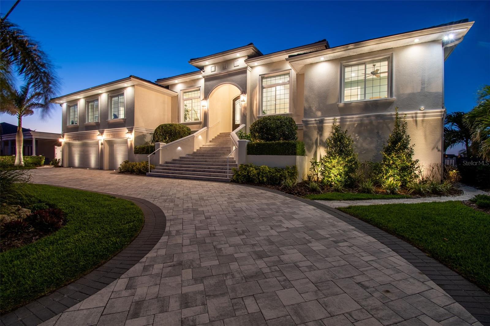 Step into this exquisite custom-built elevated waterfront home, nestled in coveted Brightwater Beach Estates and prepare to be in awe! A true coastal retreat, this FEMA-compliant masterpiece boasts unparalleled panoramic views of tranquil Boca Ciega Bay, with each bedroom and living areas offering unobstructed vistas to the north and south. The home features impeccable craftsmanship with every detail thoughtfully considered, from the luxurious tile flooring and elegant crown molding to the coastal-chic decor that is fresh, neutral, and elegant.
Designed for both comfort and style, the expansive floor plan offers 5 spacious bedrooms (2 currently used as offices), 4 full bathrooms (3 of which are ensuite), state-of-the-art Thermador kitchen appliances, custom kitchen cabinetry and an oversized laundry room. The gracious open layout is perfect for entertaining, while the 1,800+ square feet of covered outdoor living space invites you to relax and enjoy the natural beauty of your surroundings. Lush tropical landscaping surrounds the home, complementing the Coastal Mediterranean architecture and adding to the home's serene atmosphere.
For boat enthusiasts, the home is a dream come true with a 50-foot dock and 10,000 lb boat lift, built in 2023, providing quick access to the Gulf from Boca Ciega Bay. The new seawall (2021) ensures your waterfront property remains pristine. Enjoy the ultimate in outdoor living with a  stunning swimming pool with waterfall, outdoor kitchen and expansive covered living areas, ideal for entertaining or unwinding in your own private oasis.
Additional features include a 3-car garage with epoxy flooring, a wood-paneled elevator cabin, natural gas-powered tankless water heater, oven and BBQ, just to name a few. Built for resilience, both floors of this home are of solid concrete block construction. With generous storage, top-tier finishes throughout and a meticulous design, this home is truly a one-of-a-kind tropical retreat.
Just a short stroll to shops, dining and one of the nation’s top white-sand beaches, as well as a short drive to vibrant downtown St. Petersburg, this home offers the perfect balance of tranquility and convenience. With quick access to major airports, this property represents the epitome of luxury waterfront living.
Welcome to your dream home—where no detail has been overlooked.