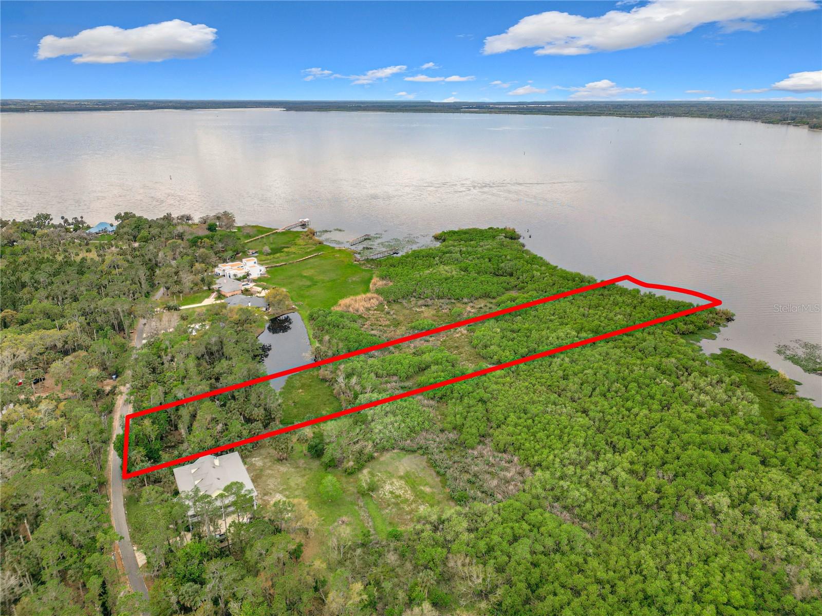 Discover a rare opportunity to own 2.88 acres in the desirable Stone Island, golf friendly community of Enterprise, FL. This unique property offers a peaceful natural setting with a pond, lake access, and the perfect balance of privacy and outdoor living potential. Create your dream retreat with custom pathways, gathering areas, and even the possibility of a private boat ramp to enjoy the waterfront lifestyle. Surrounded by beautiful conservation scenery and mature Florida landscape, this property provides a serene, park like atmosphere while still offering space to custom build and enjoy. Stone island amenities include a private boat launch, horse stables, tennis courts, playground, and access to Lake Monroe and the St. Johns River.
