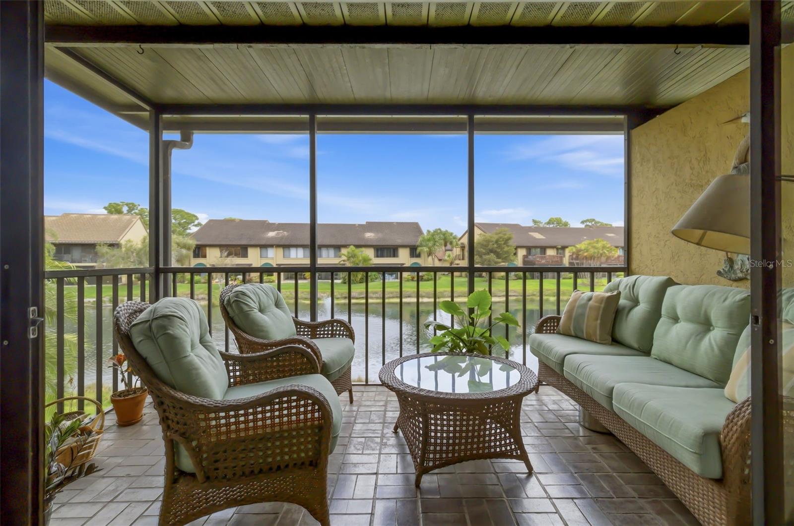 Welcome to this charming 2 bedroom, 2 bath walk up condominium in the highly desirable Ashton Lakes community. This light and bright residence features high ceilings that create a spacious and open feel throughout the home.

Enjoy relaxing on the screened lanai while taking in peaceful lake views and the natural beauty of the surroundings. The comfortable floor plan includes a spacious primary bedroom with a walk in closet and private ensuite bath, creating a quiet and inviting retreat. The guest bedroom is conveniently located near the second bathroom and can easily serve as a guest room or home office. Additional features include an inside laundry room and an assigned carport.

Ashton Lakes is set on 33 acres of beautifully maintained grounds with four scenic lakes and offers a resort style lifestyle with a wide range of amenities. Residents enjoy two heated swimming pools, including one large pool with a lap lane, tennis courts, pickleball courts, shuffleboard courts, grilling areas, and a welcoming clubhouse that hosts an active social calendar during the winter season.

The community is connected by a convenient footbridge to Merchants Mart shopping center where you will find CVS, Ace Hardware, a liquor store, Dollar Store, and the popular Detwiler’s Farm Market.

Ideally located just 3.5 miles from the world famous Siesta Key Beach, this home also offers easy access to I 75 and US 41. Shopping, dining, schools, and hospitals are all within a short drive.

The condominium fee includes cable TV, internet, water, trash, exterior and grounds maintenance, and an on site manager, providing convenience and peace of mind.

Whether you are looking for a winter retreat or a full time residence, this lake view condominium offers a wonderful opportunity to enjoy the Florida lifestyle in a prime and convenient location.