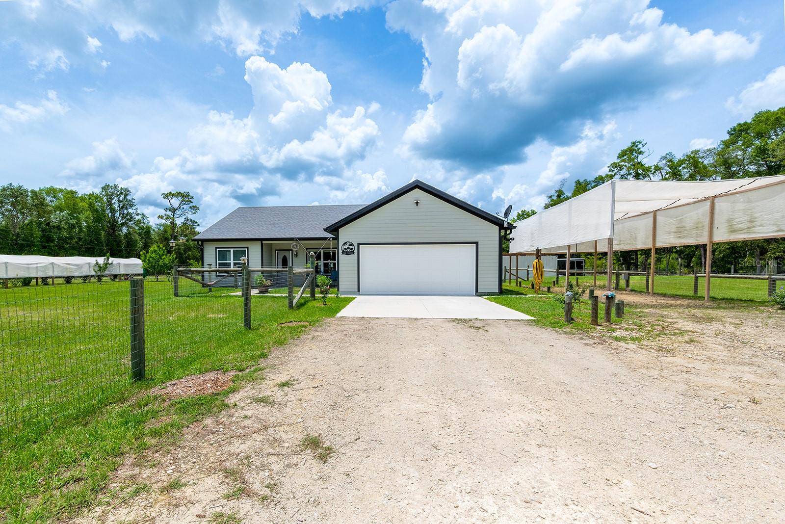Welcome to peaceful country living in Chiefland! This beautifully maintained 3-bedroom, 2-bath home sits on a fully fenced 1-acre property and offers the perfect blend of comfort, functionality, and outdoor living. Inside, you’ll find waterproof vinyl flooring, recessed lighting, granite countertops, stainless steel appliances, a dedicated office space, pantry, and spacious walk-in showers. French doors lead out to the backyard, creating a great flow for entertaining and everyday living. Outside, the property is packed with features including a covered back patio, large deck with above-ground pool, RV parking with full hookups, storage container with lean-to, and plenty of room for hobbies and recreation. Gardeners and nature lovers will appreciate the fruit trees, covered garden tunnel, and peaceful surroundings. Located in Chiefland, you’ll enjoy the charm of small-town living while being close to shopping, dining, schools, and medical facilities. The area is known for its easy access to the Suwannee River, freshwater springs, and outdoor activities including boating, fishing, kayaking, and hiking, making this property a great place to enjoy the Florida lifestyle.