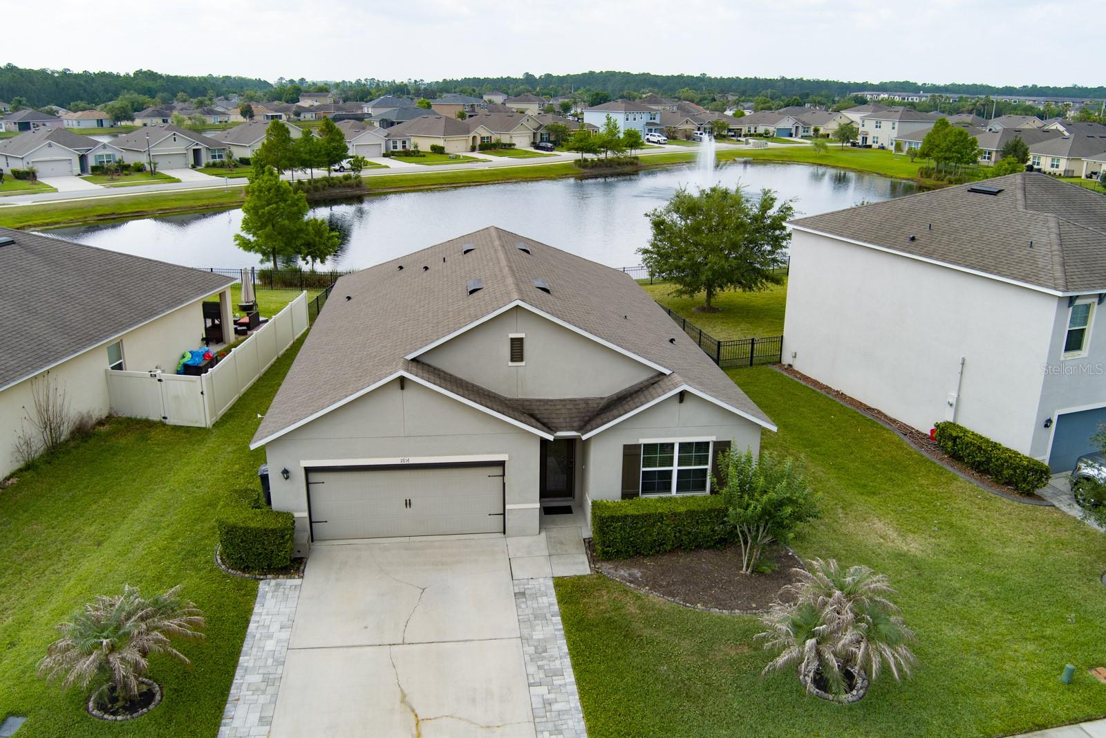 Welcome to this beautifully maintained 4 bedroom, 2 bathroom home located in Hawk's Preserve! This home features a spacious open layout with granite countertops, high end appliances and tile flooring throughout the main living areas with carpet in the bedrooms for added comfort. The laundry room includes a washer and dryer for convenience. Step outside to enjoy a stunning pond and fountain view to start your day. Ideally located just minutes to shopping, dining, top rated schools, I-95, and only a short drive to the beach. Enjoy access to the community pool and playground. With its prime location, beautiful views, and move in ready condition, this home is a must see.