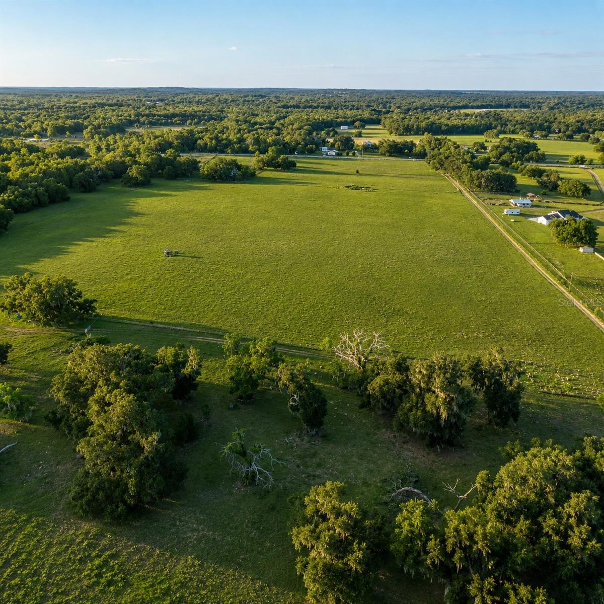 Public Remarks: 55+ ACRES + LAKE VIEWS + TWO PARCELS + WELL + ELECTRIC + POLE BARN + SHOOTING RANGES + EQUESTRIAN & CATTLE READY A rare opportunity to own 55+ acres of pristine Old Florida land in the heart of rapidly growing Hernando County near Lake Bystre and Historic Downtown Brooksville. This extraordinary property features two contiguous parcels with majestic grandfather oaks, sweeping lake views, abundant wildlife, rich agricultural land, and endless possibilities. Existing improvements include well, electric, pole barn, high-quality cement water troughs, and two custom shooting ranges already in place. Expansive pastureland makes this property ideal for cattle, horses, ranching, farming, recreation, or creating a luxury private estate or family compound. Enjoy peaceful country living with convenient access to Tampa, Orlando, Ocala, shopping, dining, medical facilities, and Florida's Adventure Coast. Whether you are looking to build a dream ranch, equestrian estate, or secure a premier land investment, opportunities like this are becoming increasingly rare in Hernando County.