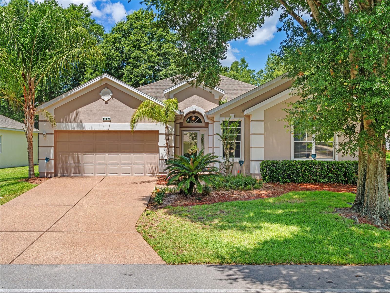 Welcome to the highly desirable 55+ golf community of Kings Ridge in beautiful Clermont, Florida! This well-maintained 2-bedroom, 2-bath home is situated on a spacious corner lot adorned with beautiful mature trees that provide both charm and shade.

The popular St. James floor plan offers a versatile bonus room that can easily serve as a home office, hobby room, guest space, or potential third bedroom area. The spacious kitchen features abundant cabinetry and storage, making meal preparation and organization a breeze.

Relax and unwind in the expansive 19' x 9' screened patio, complete with vinyl windows, creating a comfortable year-round living space perfect for entertaining, enjoying your morning coffee, or taking in the peaceful surroundings.

Kings Ridge offers an active Florida lifestyle with outstanding amenities including golf, an exercise room, three heated swimming pools, tennis, pickleball, clubs, activities, and so much more. Conveniently located near shopping, restaurants, medical facilities, and major roadways, everything you need is just minutes away.

Come discover why so many residents love calling Kings Ridge home—it's more than a neighborhood, it's a lifestyle!