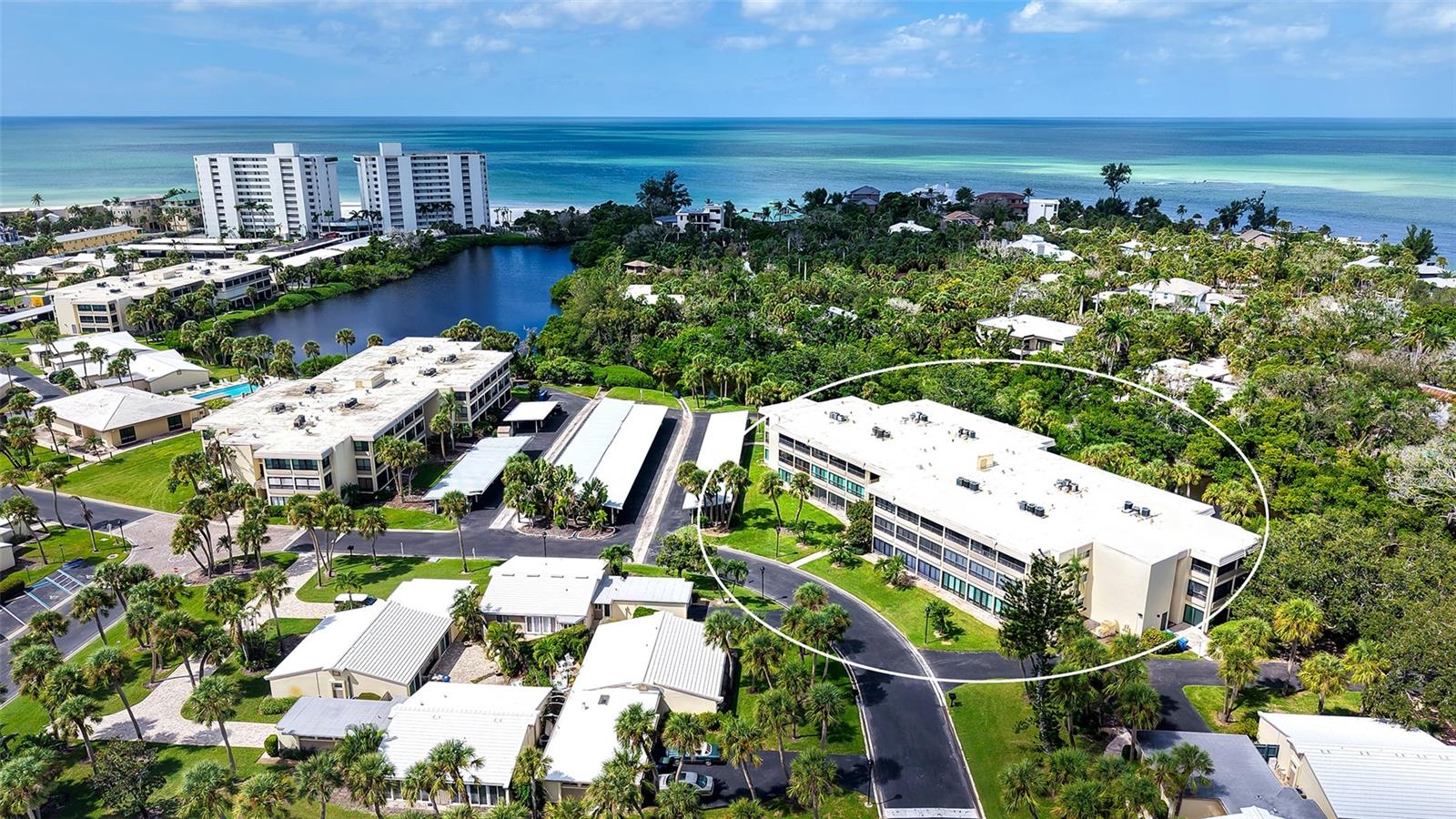 Virtually Staged. GREAT PRICE IMPROVEMENT!  Welcome to this RARE, 2 bed/2 bath, double lanai corner residence with peaceful lagoon views in the premiere Gulf front property of Whispering Sands! Nestled in the desirable Sunset House building, this freshly painted, updated unit offers a quiet, private setting, with serene views of lush landscaping and the shimmering lagoon with its abundant fish, turtles, and aquatic life. A wonderful entry hall leads into a spacious OPEN CONCEPT floor plan, where the kitchen, living and dining areas flow together to create a wonderful, flexible gathering space. The living space has been extended into what was originally an enclosed 24' x 7' lanai, resulting in the creation of additional valuable interior living space under air, flanked on all sides with floor to ceiling sliders. Sliders open into a private, sunny brick paver patio, perfect for grilling, gardening, or simply relaxing in the surrounding natural beauty. You'll enjoy hosting friends and family in your NEW 2025 kitchen featuring granite countertops, LG stainless appliances, soft-close cabinetry, tile backsplash, breakfast bar, & tray ceiling. The primary and guest bedrooms each include a set of charming French doors that open into the tiled, screened and glassed lanai with direct views into the lagoon. Updated in 2024, both bathrooms include new granite countertops, soft close vanities & fixtures, and recessed lighting. All of the sliders in this unit are Miami Dade hurricane impact rated. 2024 HVAC system. 2025 water heater. Whispering Sands is a 55+ Gulf front community ideally situated just steps to the colorful shops & restaurants of Siesta Key Village offering two heated pools, clubhouse with catering kitchen and fitness rooms currently undergoing complete remodeling, canoe/kayak storage, beachside Tiki Hut & grills, and 800’ of its own beach access on the Gulf! Thoughtfully updated, inviting, and perfectly private, this peaceful corner retreat offers the perfect blend of indoor/outdoor living on beautiful Siesta Key.