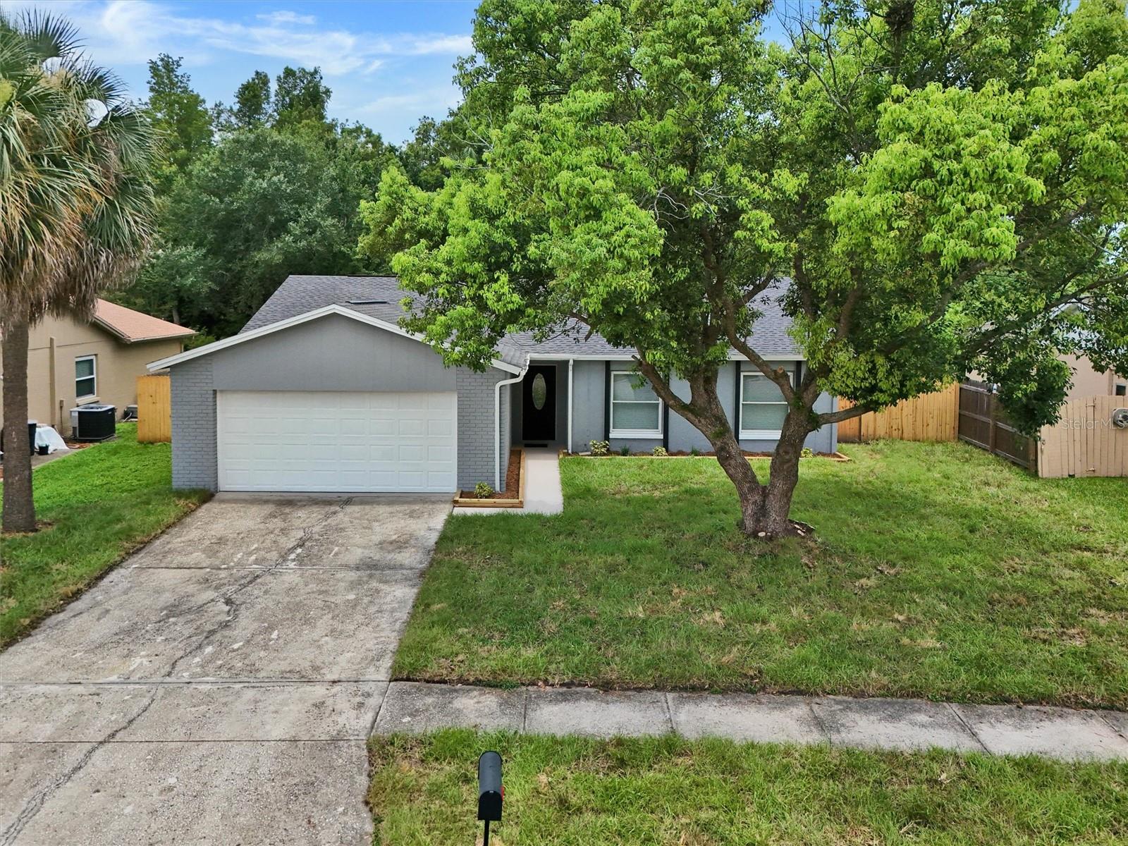 WELCOME HOME!! Start your next chapter in this beautifully remodeled 4-bedroom Carrollwood pool home—perfect for first-time buyers, growing families, or anyone looking for a move-in-ready home with nothing left to do. Enjoy peace of mind from day one with a BRAND-NEW roof, BRAND-NEW A/C, fresh interior and exterior paint, and durable laminate wood flooring throughout. The bright, open kitchen is designed for everyday living and effortless entertaining, featuring brand-new wood cabinetry, beautiful quartz countertops, and stainless steel appliances. Whether you're packing school lunches or hosting weekend dinners, this space is sure to impress. All four bedrooms offer comfortable space for family, guests, or a home office, while both bathrooms have been tastefully updated with modern finishes. Every improvement was made with style, functionality, and long-term comfort in mind. Step outside and discover one of this home's standout features. The screened lanai overlooks a sparkling pool and a fully fenced backyard with no rear neighbors, backing to a peaceful natural area filled with mature trees and lush greenery. Whether you're enjoying your morning coffee, hosting pool parties, or relaxing after a long day, you'll love the private, park-like setting. There's also plenty of room for kids and pets to play, gardening, or storing your boat or RV. An oversized two-car garage provides even more storage and functionality. Location is everything, and this home delivers. Enjoy NO HOA, NO flood insurance required, and quick access to Publix, EOS Fitness, Costco, the Veterans Expressway, Citrus Park Mall, the Upper Tampa Bay Trail, parks, hospitals, shopping, dining, area beaches and top-rated schools. With all the major updates already completed, all that's left to do is move in, unpack, and start making memories.