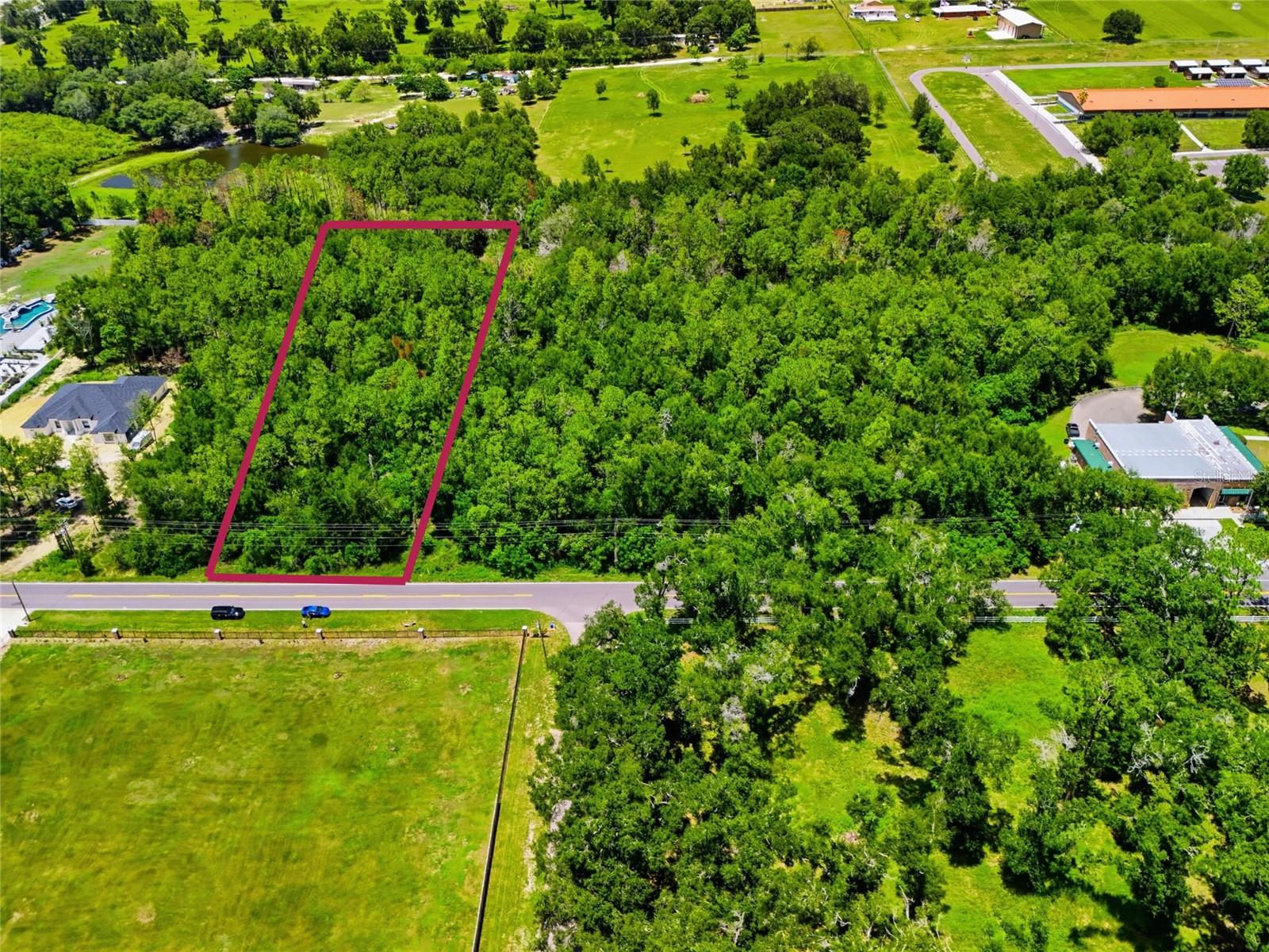 Discover the perfect place to build your dream home on this beautiful 2.50-acre wooded lot located on Centennial Road in Dade City! Situated on a paved road surrounded by gorgeous custom homes, this property offers the ideal combination of privacy, space, and convenience. Zoned AR (Agricultural Residential), giving you the flexibility to build your dream home or place a manufactured home on the property. County water connections are available, adding convenience as you plan your future homesite. Best of all, toss those HOA and CDD fees out the window! Enjoy the freedom of country living without the extra community fees. Bring your builder, your manufactured home plans, and your vision and make this peaceful 2.50-acre piece of Dade City your own!