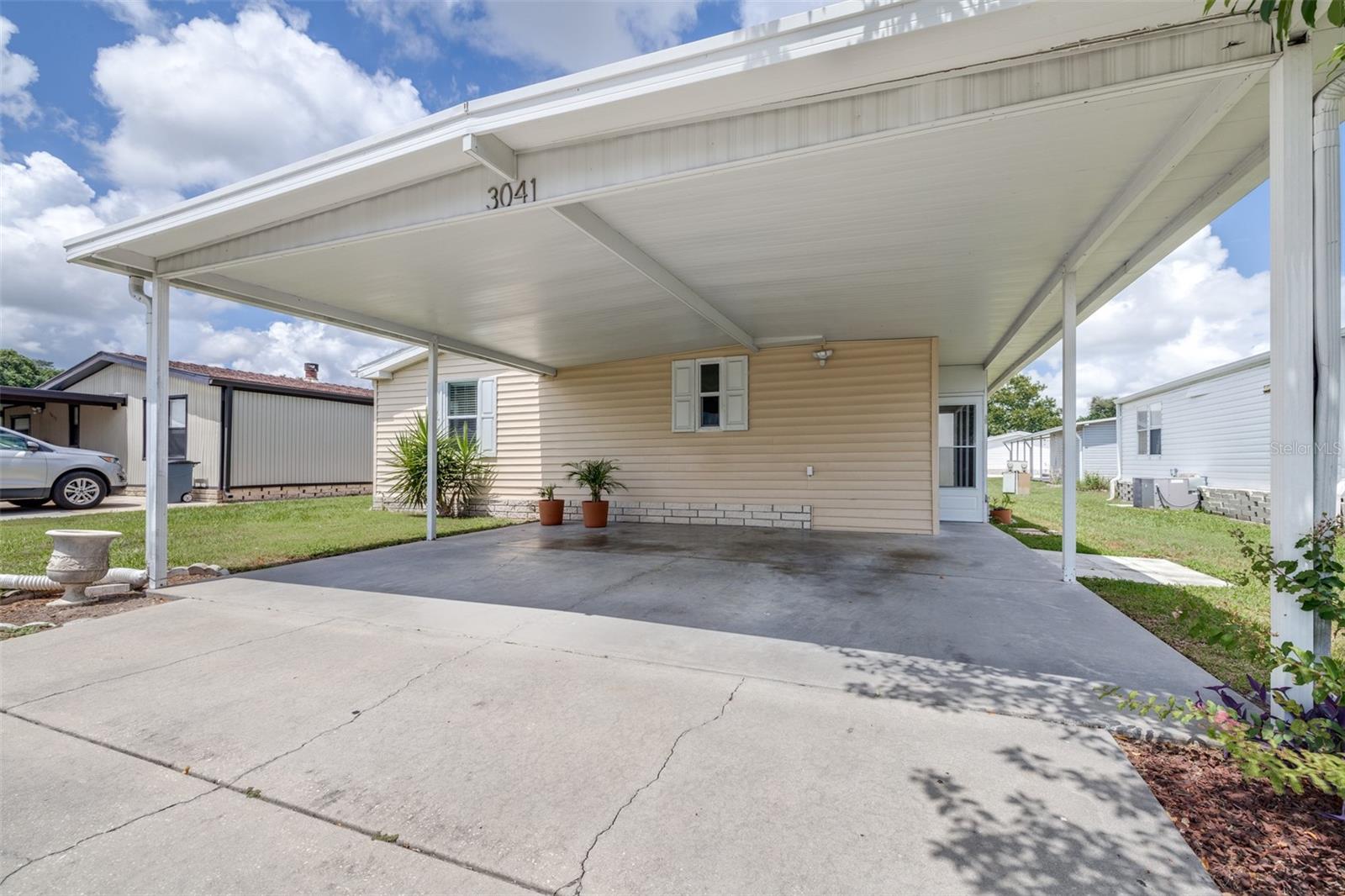 Welcome home to Timber Lake Estates! This beautifully maintained 3-bedroom, 2-bathroom double-wide manufactured home features 1,170 sq ft of comfortable living space in a desirable resident-owned, gated community with NO age restrictions. This home has been thoughtfully updated over the years, including a 2017 roof, windows, and interior remodel, a 2023 water heater, a 2025 HVAC system, a 2025 washer and dryer, a 2025 dishwasher, and a brand-new vapor barrier installed in 2025 for added peace of mind. Inside, you'll find an inviting floor plan featuring laminate and ceramic tile flooring, ceiling fans, and plenty of natural light throughout. Enjoy easy Florida living with a covered carport and a low-maintenance exterior. Timber Lake Estates offers outstanding amenities, including clubhouses, pools, recreational activities, and a welcoming community atmosphere. Conveniently located near shopping, dining, major roadways, Wiregrass Mall, Tampa Premium Outlets, Costco, and everything Wesley Chapel has to enjoy. Affordable living in a fantastic location—schedule your showing today!