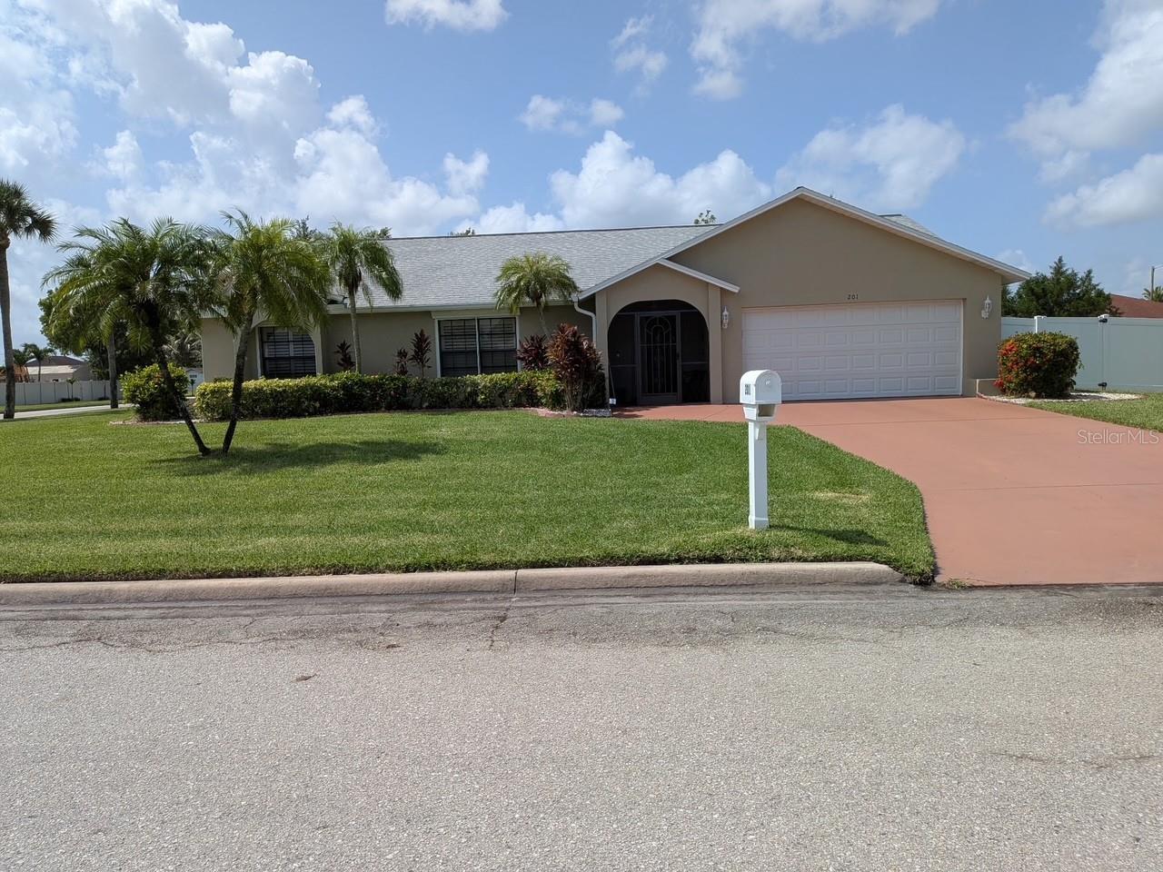 Charming custom home on an oversized corner lot (0.35 acre), located in the subdivision of Amberwood Estates. This split floor plan offers an L shape living/dining room area that leads to the Florida room. The fully equipped kitchen offers plenty of cabinet space, granite counter tops, and a breakfast nook with skylights for additional natural lighting. The primary bedroom offers a walk-in closet and an en-suite bathroom with dual sinks, granite counter top, and shower. There are two additional bedrooms plus a guest bath. Relax in the comfort and privacy of the Florida room; this space can be converted into another bedroom if needed. Neutral interior paint and ceramic tile throughout. Exterior paint and a/c done in 2/2026. Plantation shutters in all windows as well as electric hurricane shutters. This home is ready for a new owner, see it today!