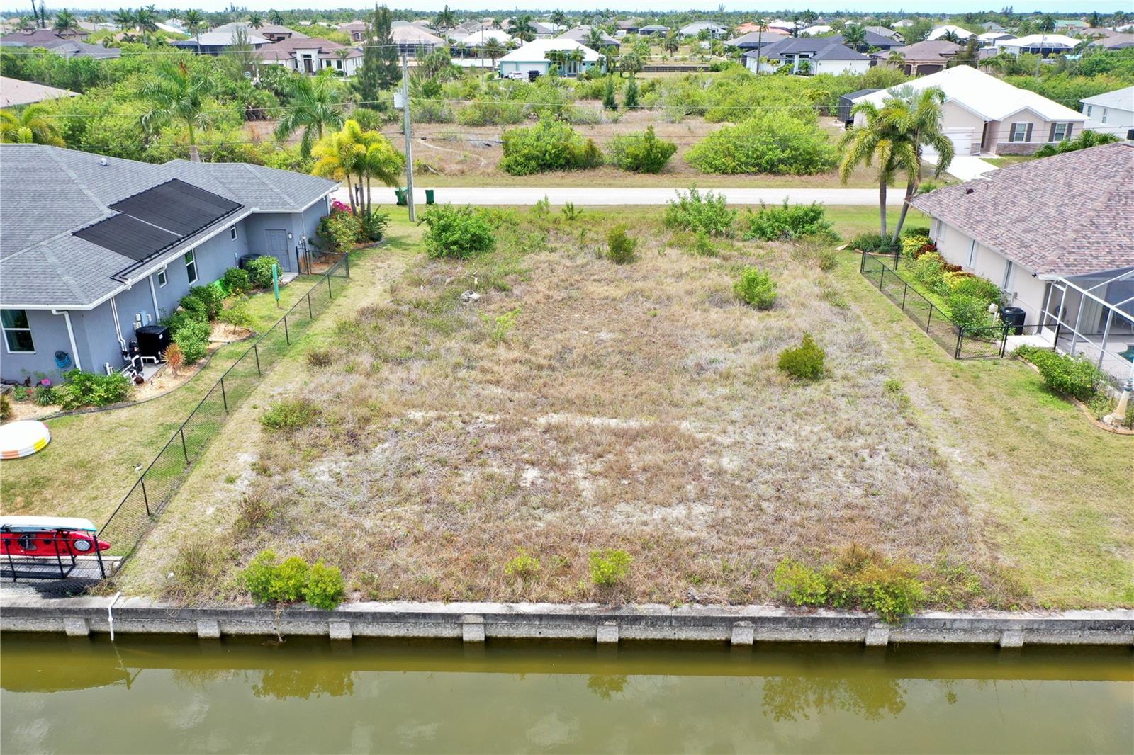 Build your Florida dream on this prime .23-acre waterfront homesite in the sought-after, deed-restricted community of South Gulf Cove. This 10,000-square-foot lot features 80 feet of road frontage and 80 feet of existing concrete seawall. Having a seawall already in place provides immense value, saving you tens of thousands in construction costs and months of permitting time while offering immediate erosion protection for your future private dock. The property sits one fixed bridge and a lock away from open water! The property is build-ready with PUBLIC WATER and SEWER available. Enjoy the perfect balance of natural light and seasonal comfort with a desirable NORTH-FACING rear view over the canal, offering bright afternoons without the intense, direct heat of the mid-day Florida sun. It is NOT in a scrub jay zone and contains NO wetlands, allowing you can move forward with construction plans and environmental clearances with total confidence. There is ample room on this lot to design a sprawling floor plan alongside a custom pool overlooking the tranquil Taurus Waterway.

Ideally situated for recreation, this property is near San Domingo Park, where residents enjoy scenic nature paths and peaceful fishing spots. You are also minutes from the South Gulf Cove community park, which features a playground, basketball courts, and a public boat ramp. For commuters, I-75 is a convenient 15-minute drive, providing a direct gateway to Sarasota, Tampa, and Fort Myers. Nature lovers will appreciate being near pristine preserves with extensive hiking trails, including the Charlotte Harbor Preserve State Park.

The lifestyle here is world-class for sports and outdoor enthusiasts. You are perfectly positioned between two MLB Spring Training facilities: the Tampa Bay Rays at Charlotte Sports Park and the Atlanta Braves at CoolToday Park. Golfers will find paradise with championship courses like Riverwood and the Rotonda West courses all within a 15-to-20-minute radius. When the Gulf calls, you are only 20 minutes from the legendary beaches of Boca Grande and 25 minutes from Englewood Beach. Best of all, your backyard is the starting point for some of the best fishing in the world; enjoy immediate access to elite flats fishing for snook or venture to the Boca Grande Pass for legendary tarpon fishing. This is a rare opportunity to secure a premier canal-front lot in a vibrant boating community.