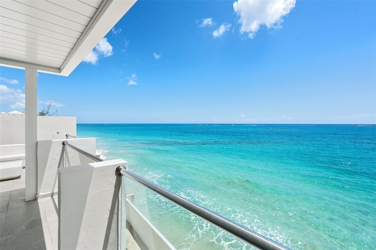 Paradise awaits in the ultimate waterfront beach home. Located within the prestigious neighborhood of Ocean Park, San Juan’s most sought-after gated beach community, you’ll find this 5-bedroom, 5.5-bathroom, 4,863 square foot townhouse. Meticulously renovated over four floors, this architectural marvel features cathedral ceilings and open concept living. Built in 1998 by famed architect Mario Montilla and reimagined by Carlos Salazar in 2023, the design is focused on optimizing the privileged beachfront location and its unique surroundings. 
Witness the dramatic beauty of the ocean from the moment you walk in, as 20-foot ceilings and a wall of windows create panoramic vistas of the Atlantic Ocean. Bright and airy, the first two floors of living space provide many options for entertaining or relaxing. The modern kitchen with quartz countertops, double dishwasher, Smeg and Kenwood appliances, faces the ocean. Custom oak woodwork and cabinetry in blue hues adorn the bar, complete with an industrial ice maker and a beverage cooler. A flex room and full bathroom currently outfitted as a music studio are the prefect home office or additional bedroom. Retreat to the upper floors where sumptuous double primary suites on each floor feature ensuite bathrooms with Grohe fixtures, custom Italian ceramic tile, double vanities, soaking tub, and steam shower. From the highest floor, experience the crowned jewel of this magnificent residence - the substantial terrace with 180-degree views of the beach and ocean. This perfect oasis is conveniently outfitted with a wet bar, grill, outdoor kitchen, outdoor shower, and Vondom furniture. A custom electric pergola is outfitted with lights and a windscreen to maximize comfort at any time of day. Every modern convenience has been considered in this masterfully recreated abode. This residence has full backup diesel generator, 2 water cisterns, electric storm shutters, and industrial grade garage doors. The garage fits 4 cars with a private entry directly into the home for discretion, security, and convenience. Garage is also customized for ample storage of all your beach gear. In addition, a private outdoor side yard can be outfitted with a jacuzzi, pool, or garden. This prime location is a mere 8 minutes from the Luis Munoz Marin International Airport, the city’s best schools, and the dynamic nightlife and gastronomy of Condado Beach.

Ocean Park is a dreamy, tree-lined beach community within the city, this rare find in the heart of it all can be yours today.