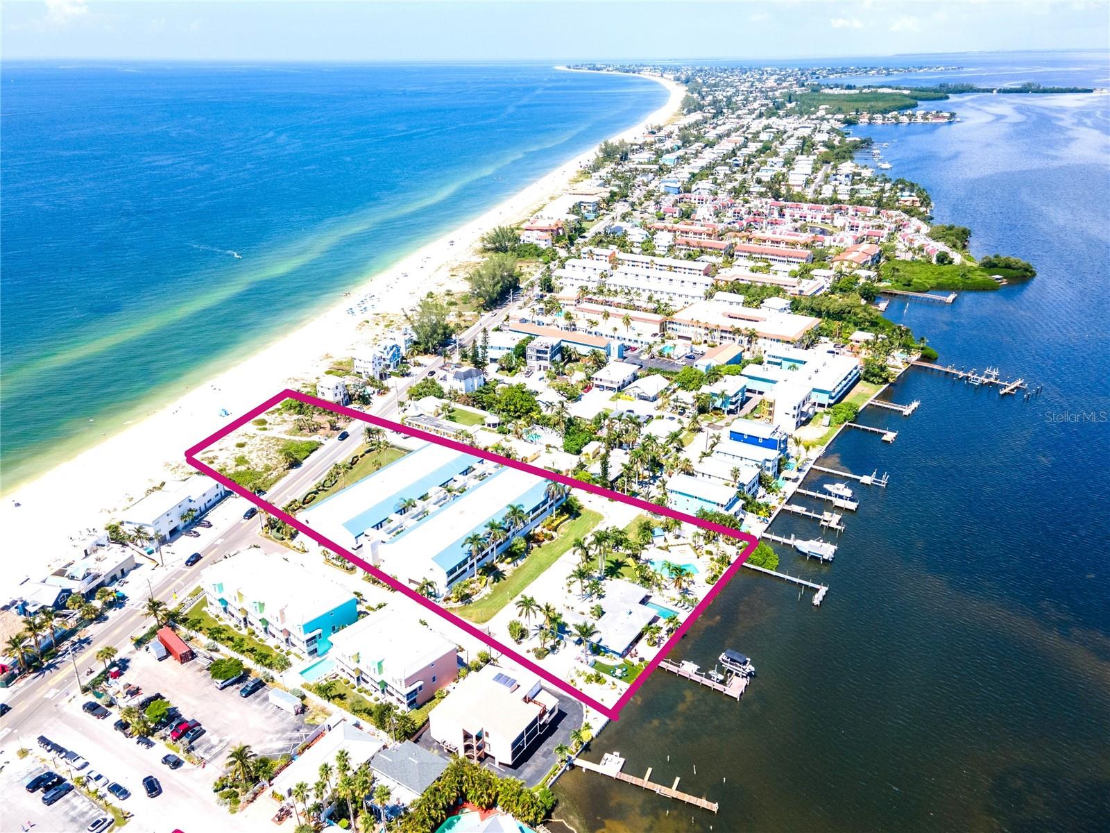 DIRECT BEACH VIEWS from this spacious, updated 2/2 unit in the Gulf-to-Bay complex of "Summer Sands". This beautiful, elevated  unit had NO interior impact from the 2024 hurricanes.  Updates include a NEW A/C installed 4/1/25, wood-appearance LVP flooring for durability and a time-less look, an updated kitchen with new cabinetry & stainless appliances, bathroom renovations, new, tasteful furniture & decor and a wine fridge added to the bar in the dining space. There is a spacious, enclosed lanai with access from both the living room & the primary bedroom. Watch the sunsets without having to leave your home! New grounds landscaping, pool updates & elevator replacement project were recently completed.  This great complex is located just across the street from the beach with spectacular views of the Gulf AND extends to the Intracoastal Waterway on the bay side to catch sunrises as well. "Summer Sands" offers a private, heated pool, jacuzzi & a scenic dock on the bay for residents & owners. Two, assigned car spaces and the elevator are conveniently located near this great END unit condo. "Summer Sands" owns the vacant, Gulf front parcel, which protects the unobstructed BEACH VIEWS of this fantastic complex. Looking for the best the Florida Gulf Coast has to offer?  Here it is!