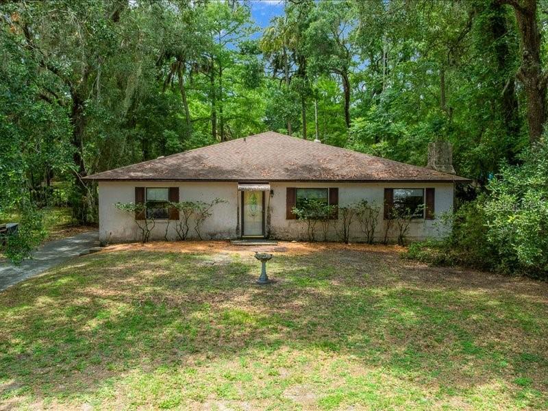 Discover the potential of this spacious 4 bedroom, 2 bath home offering 2,304 square feet of living space on a rare 0.87 acre corner lot in the heart of Inverness! Situated on two separate parcels, this unique property provides endless possibilities. The additional 0.43 acre parcel may offer the opportunity for another home, making it ideal for multigenerational living, future investment income, or simply enjoying the extra privacy and space.

Adding to its appeal, the property features a canal in the backyard with access to Lake Tsala Apopka and Lake Panasoffkee, offering endless opportunities for boating, fishing, kayaking, and enjoying Florida’s natural beauty right from your own backyard. The interconnected waterways also provide access to the Withlacoochee River and other popular waterways throughout the area, making this a great location for water enthusiasts.

Step inside to find an inviting open floor plan centered around a stunning stone fireplace in the main living room. The kitchen offers an abundance of cabinet and countertop space with plenty of room to add a center island. An additional family room located just off the kitchen provides even more space for entertaining, relaxing, or creating a flex area to fit your lifestyle.

The oversized primary suite features a large walk in closet and an en suite bathroom complete with dual vanities, a soaking tub, and a separate shower. Two guest bedrooms are conveniently located near the guest bathroom, while the fourth bedroom is situated on the opposite side of the home, making it perfect for a private guest suite, home office, hobby room, or flex space.

With solid construction, great bones, and a highly desirable location, this home presents the perfect opportunity for a buyer to add their personal touches and create their dream property. Recent updates include a new roof in 2019 and HVAC system in 2022, providing peace of mind for years to come.

Whether you’re looking for a waterfront retreat, investment opportunity, or a property with room to grow, this Inverness gem is full of possibilities!