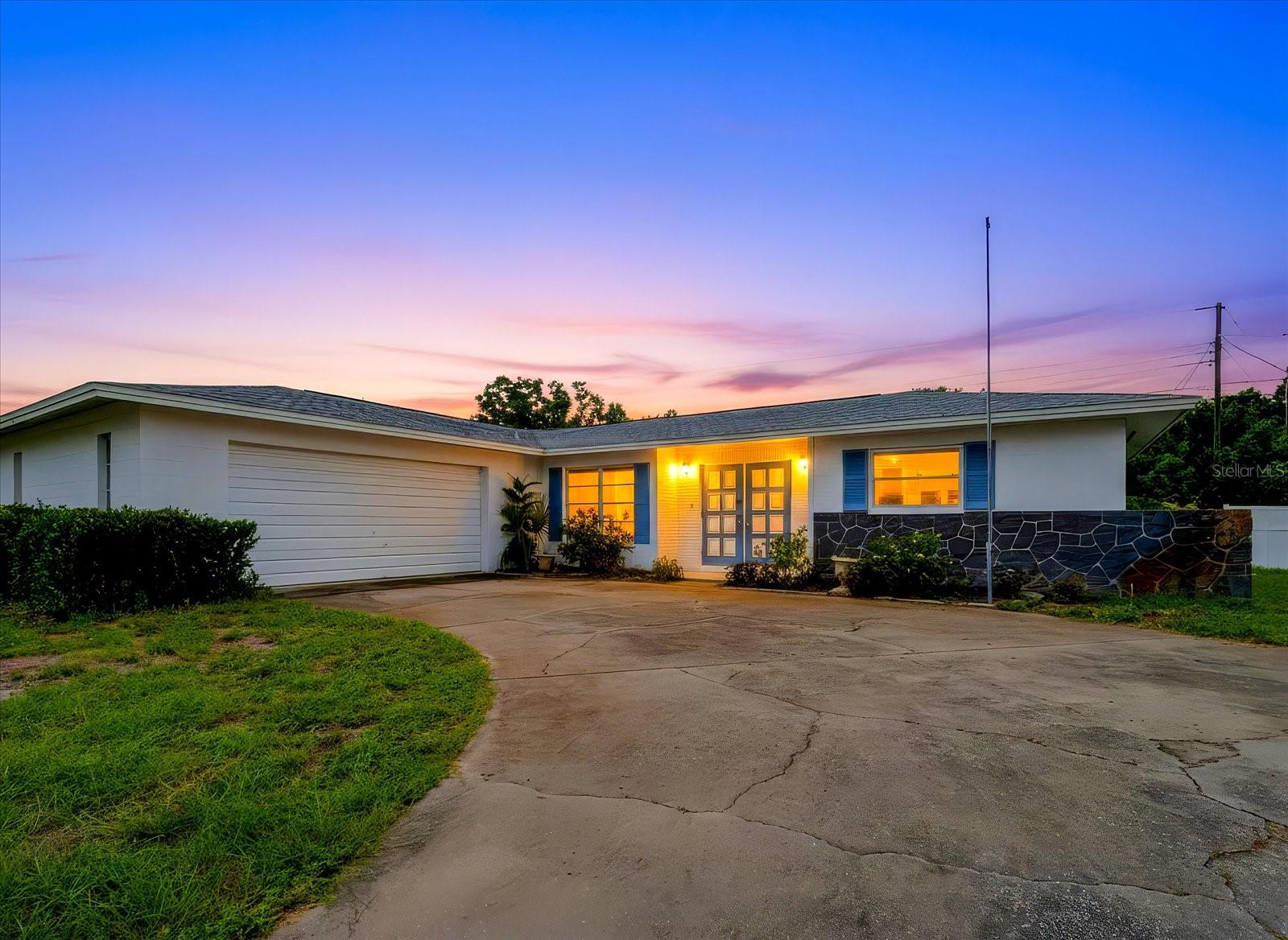 Vintage Character. Endless Possibilities. This nostalgic Florida gem offers the perfect blend of timeless character, generous living space, and endless potential. A fresh white block façade accented by soft blue shutters creates an elegant yet approachable exterior, while the stately double-door entry adds a touch of regal sophistication to the home's curb appeal. following suit, the side-oriented and more hidden garage adds to the home's welcoming front elevation; with only its windows, landscaping, and inviting entry to take center stage. 

Inside, you'll first find a traditional formal living and dining room combination, reflecting the thoughtful layouts that made homes of this era so desirable. Beyond this space to the rear of the home, an additional living area offers additional flexibility posing as a casual family room, home office, hobby space, reading nook, or whatever best suits your lifestyle. True to its era, the home's kitchen was thoughtfully designed tucked away from the formal living and dining rooms, reflecting a time when hosting meant welcoming guests into beautifully appointed gathering spaces while keeping meal preparation, cooking aromas, and everyday kitchen clutter quietly behind the scenes. It's a nostalgic layout that many can still appreciate for its privacy and practicality. Remember when holiday dinners had their own dining room and guests gathered in the formal living room before dessert? This home can proudly carry on that tradition.

While many design trends have come and gone, the split-bedroom floor plan remains a favorite, offering privacy with each bedroom situated on its own side of the home. The secondary bedroom sits on the right side of the home with a large walk in closet and a nearby full bathroom with an oversized counter, plenty of cabinet space and a shower/tub combo. Much like the home's classic floor plan, the primary suite was intentionally placed away from the main gathering spaces, quietly tucked into the rear left corner of the home for a sense of privacy that never goes out of style. The room, well lit with natural light from three windows, is spacious and has its own nearby walk-in closet and private bathroom with large counter space and ample cabinetry as well as a shower and toilet closet. This was an era when square footage was devoted to spacious rooms instead of squeezing in extra walls and this home hosts the extra square footage rooms! 

Major updates have already been completed! The ROOF was replaced in 2019, followed by a new HVAC system in 2024.

Located in an established non-HOA community, you'll enjoy the freedom that comes without additional association fees or restrictions, all while being conveniently located to shopping, dining, beaches, and everything the Florida lifestyle has to offer.

Some homes tell a story. This one has been telling them since an era of station wagons in the driveway, holiday dinners in the formal dining room, and neighbors who became lifelong friends. Whether you choose to preserve its nostalgic charm or tastefully introduce modern updates over time, its generous proportions, timeless floor plan, and enduring craftsmanship provide the perfect canvas. This Florida classic is ready to begin its next chapter...perhaps with you writing the ending.
