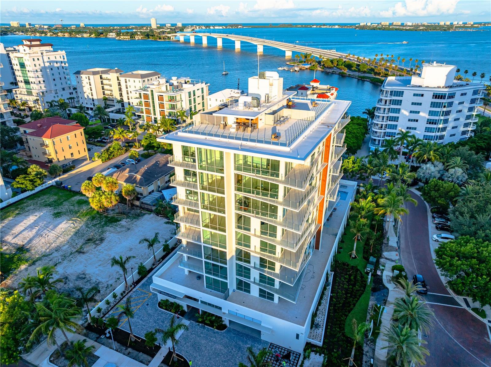 Move-In-Ready, New Construction. Introducing Unit 401 at The Evolution on Golden Gate Point.

Step into unparalleled luxury designed by renowned local architect Mark Sultana, DSDG and furnished by interior design team, Clive Daniels. Unit 401 at The Evolution, where breathtaking westward views of Sarasota Bay greet you every day. Experience mesmerizing sunsets, sailboats gliding across the water, and the twinkling evening lights of the Ringling Bridge—all from the comfort of your home.

Stunning Interior Features:
 • Professionally staged by Clive Daniel Home, blending elegance and comfort.
 • An expansive wrap-around deck offers panoramic views of Sarasota Bay and downtown Sarasota, creating the perfect setting for relaxation or entertaining.
 • The open-concept living space features a dry bar with two Sub-Zero wine refrigerators, an electric fireplace, and beautiful porcelain tile flooring throughout.
 • The chef’s kitchen boasts upgraded Italian cabinetry and a premium water filtration system providing instant hot, cold, and carbonated water.
 • A large den with elegant French glass doors offers flexibility as an office, media room, or additional guest space.
 • The entire home is fully wired for future electronic shades, offering convenience and modern luxury at your fingertips.

Luxurious Private Retreats:
 • This spacious 2,505 sq ft residence features 3 bedrooms and 3 bathrooms, designed to live like a single-family home.
 • Two of the bedrooms are ensuite, including the lavish primary suite with sweeping views of Sarasota Bay and Golden Gate Point.
 • The primary spa bathroom is a sanctuary, featuring a freestanding porcelain soaking tub, dual vanities, and refined finishes.
 • The private balcony off the primary bedroom invites peaceful mornings and serene evenings overlooking the water.

Exclusive Lifestyle & Amenities:
 • Includes a private deeded 2-car garage, offering added convenience and security—a rare feature in luxury condo living.
 • The Evolution offers boutique luxury living with only 20 exclusive residences.
 • Indulge in the rooftop oasis with panoramic bay views, a spa, outdoor lounge with a fireplace, and sunsets stretching to the Gulf of Mexico.
 • The amenities floor includes an outdoor kitchen poolside, a yoga room, fitness center, imported sauna, and a stylish club room—all designed for relaxation and entertainment.
 • Enjoy the convenience of a full-time concierge service and secure access throughout the building.

Unmatched Sarasota Lifestyle:
 • Perfectly positioned in the heart of Sarasota, The Evolution offers walkable access to downtown dining, art galleries, theaters, and the vibrant energy of the city.
 • Just minutes from St. Armands Circle, Lido Beach, and Sarasota’s renowned cultural attractions, you’ll experience the best of the city and the tranquility of waterfront living.

Unit 401 is more than a residence—it’s your gateway to the vibrant Sarasota lifestyle, where luxury meets convenience and every day feels like a getaway.