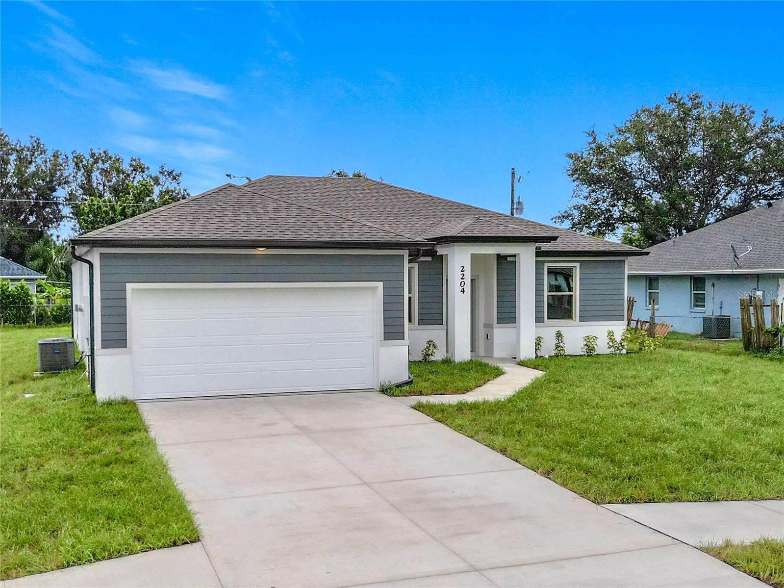 NOW OFFERING A 4.99% RATE ON AN FHA 5/1 ARM PLUS 5K IN CLOSING COSTS OR 3% TOWARDS CLOSING COSTS WITH PREFERRED LENDER. Great price with luxury features and ready now! A newly constructed home with city water and septic system in North Port, with no HOA fees! Great location for quick access to schools, the city center, medical conveniences, parks and the highway. This affordable new home is ready for you and is just what you've been looking for! The Acosta plan by Resicraft Homes has 9'4" tall ceilings, a nice open layout with a versatile floor plan and a Key West flair with the exterior architectural details. The house features 4 bedrooms, 2 full bathrooms, dining room, a living room, an open kitchen and a 2-car garage with 1810 square feet of living space and an irrigation system for your lawn.  The living space is well utilized with high ceilings and many windows providing natural light. The interior features will provide you with the quality and luxury you were looking for in your new home. This home has a split floor plan with the primary suite on one side of the home and the guest bedrooms on the other. The primary bedroom has a tray ceiling and large windows that let in natural light. You'll also enjoy a resort-style bathroom with a spacious walk-in shower with floor-to-ceiling tiled walls and a glass enclosure. It also features a linen closet, double vanity and a large walk-in closet. The living room features large windows and several LED fixtures providing plenty of light with access to the covered lanai. The living room is open to the kitchen, where you'll find a huge center island with extra seating for casual dining and plenty of cabinets. The kitchen features stainless steel appliances, Shaker-style cabinets with crown molding, decorative hardware, subway tile backsplash and granite countertops. The dining room is located at the front of the house, with large windows allowing for plenty of natural light. The home includes luxury vinyl plank flooring in the main living areas and bathrooms for durability and comfort. You'll love these floors! They are easy to maintain and offer a modern design, perfect for new homes. Other features include the same beautiful Shaker-style cabinets with hardware and granite countertops in the bathrooms, 5-inch baseboards, a garage door opener, gutters on the exterior, R38 insulation, a 16 SEER HVAC and much more. Visit our model center and compare the features and quality with other homes and you'll see the difference. We make buying easy for you!