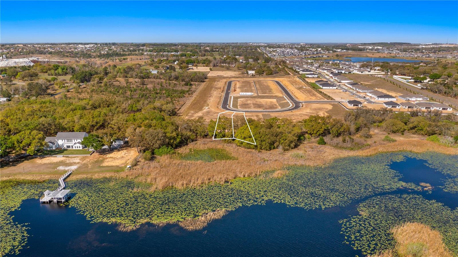 Experience true Johns Lake lakefront living on this exceptional homesite in the desirable Waterbrooke community. Perfectly positioned on the shores of Johns Lake, an almost 2,400-acre freshwater playground. This rare lot is cleared and ready to build, offering a major advantage in both time and cost when planning your custom home. With utilities available and the flexibility to bring your own builder, you can begin designing the lakefront lifestyle you’ve been dreaming about without the expense and delays of clearing or extensive site preparation.

Johns Lake is one of Central Florida’s premier lakes for water sports and outdoor recreation. Spend your days waterskiing, wakeboarding, wakeskating, or wakesurfing across its expansive open water, or cast a line for excellent fishing. For more relaxed afternoons, launch your pontoon and cruise through the lake’s many peaceful coves where birds and wildlife create a truly scenic backdrop. The property allows you to build your own private boat dock, making it easy to step out your back door and onto the water whenever the mood strikes.

While you’ll enjoy the privacy and freedom of building your own lakefront retreat, you’ll still benefit from the outstanding amenities that Waterbrooke offers its residents. The community features a beautifully designed clubhouse, resort-style pool, fitness center, playground, dog park, and miles of sidewalks that encourage an active and social lifestyle.

Convenience is another standout feature of this location. The Florida Turnpike entrance is less than ten minutes away, providing quick access for commuting while allowing you to avoid much of the Highway 50 traffic. Just minutes from the community you’ll find an abundance of shopping, services, and dining along Highway 50, including a new Costco, Publix shopping centers, and a wide variety of restaurants.

Opportunities like this are rare! A cleared, ready-to-build Johns Lake lakefront lot where you can create a custom home tailored to your lifestyle while enjoying resort-style community amenities and unmatched access to one of Central Florida’s best lakes.

This being one of 3 lakefront lots available, you can choose which one is your favorite!