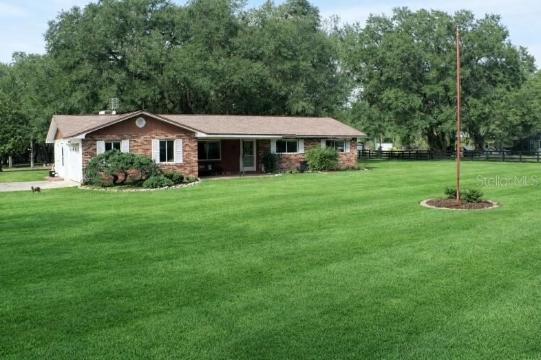 One or more photo(s) has been virtually staged. Country living on 3.02 acres in Marion County! This 3-bedroom, 2-bath ranch-style home offers approximately 1,562 square feet of living space and is zoned A-1 Agricultural, allowing for horses and a variety of agricultural uses. The property features mature trees, open green space, a fireplace, a covered front porch, a covered patio, and an attached 2-car garage.

Interior features include laminate flooring, stainless steel appliances, insulated windows, central heating and air conditioning, and spacious living and dining areas. The roof was replaced in 2018, according to permit records. Additional improvements include detached storage buildings and a separate shed that offers extra storage or workspace.

The property is served by private well and septic systems and is conveniently located, with access to Williston, Ocala, and Gainesville, while maintaining a peaceful rural setting.

Buyer to verify all measurements, zoning, land use, flood zone information, and property details.