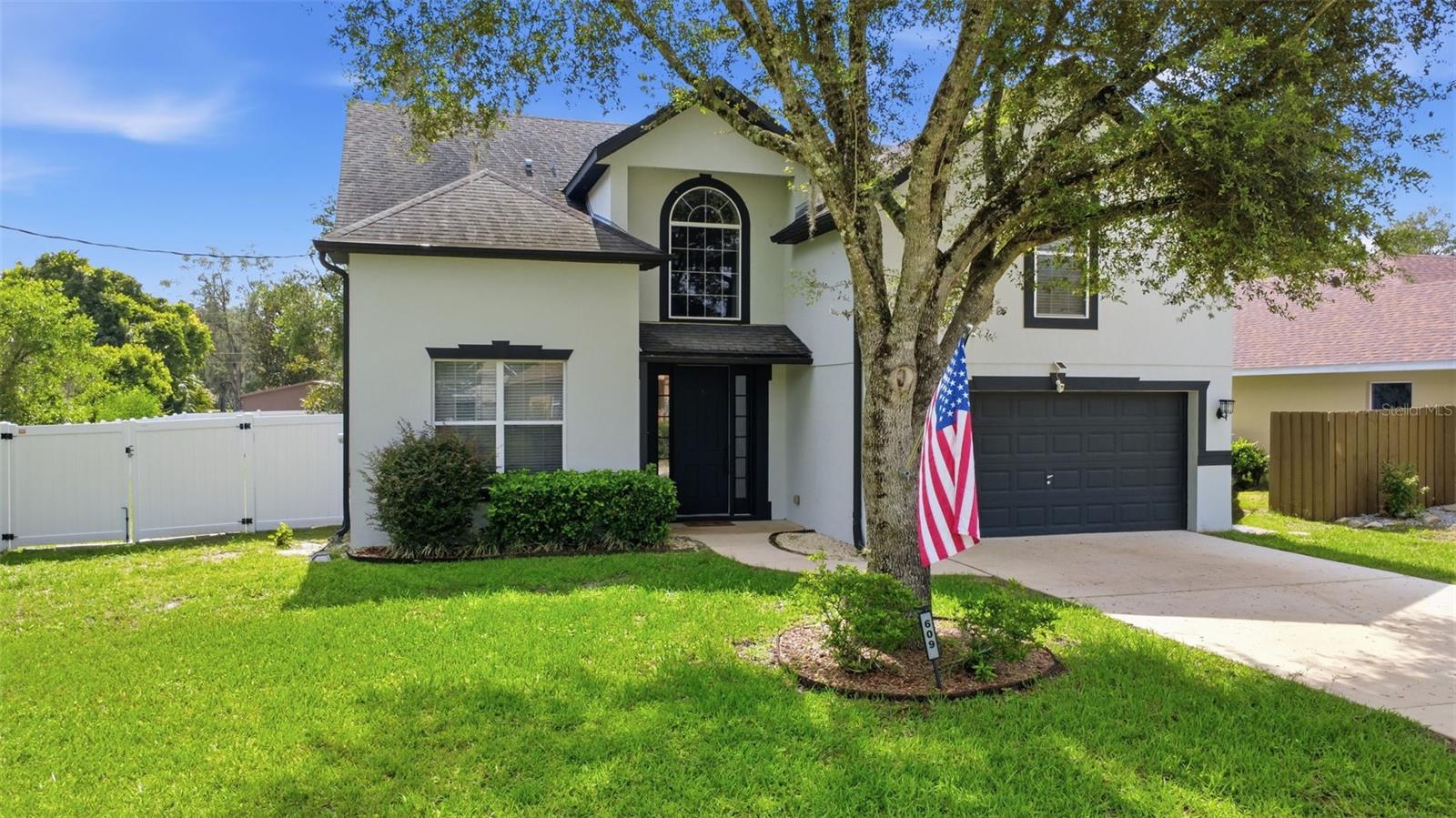 Open the front door and step into a home that's ready for its next chapter and hopefully with you in it. With 4 bedrooms, 2.5 baths, soaring ceilings, and vinyl flooring throughout the main level, this home offers plenty of space to spread out while still feeling fresh and inviting. As you enter, you'll find a convenient half bath and the primary suite tucked away on the main floor. The spacious primary bedroom features a ceiling fan, walk-in closet, and private access to the covered patio. The en-suite bathroom is designed to make life a little easier with dual vanities, separate shower & a garden tub for soaking the day away. Continue into the heart of the home where the living room opens to the oversized kitchen and dining area. Plenty of cabinet space, a nice sized island and a built-in pantry. Just off the living area, you'll find the laundry room with washer and dryer hookups, along with a generously sized storage room tucked beneath the stairs. Holiday decorations, luggage, sports equipment, mystery bins you haven't opened in years, there's room for all of it. Head upstairs and you'll discover three additional bedrooms, each with carpet, ceiling fans, and built-in closets. One bedroom features a unique step-down design that adds a little extra character, while another enjoys direct access to the Jack-and-Jill bathroom. And then there's the laundry chute. Located upstairs, it sends clothes directly into a cabinet in the downstairs laundry room. It's one of those features that sounds fun at first and quickly becomes something you'll wonder how you ever lived without. Back downstairs, sliding glass doors lead to the covered patio overlooking a spacious backyard enclosed by a vinyl fencing. The double-wide gate provides easy access for trailers, toys, or weekend projects, while the yard offers plenty of room for pets, playtime, gardening, or simply enjoying the Florida sunshine. Clean, spacious, and truly move-in ready, this home offers the kind of layout that works for multiple lifestyles while adding a few thoughtful touches that make life just a little more enjoyable.