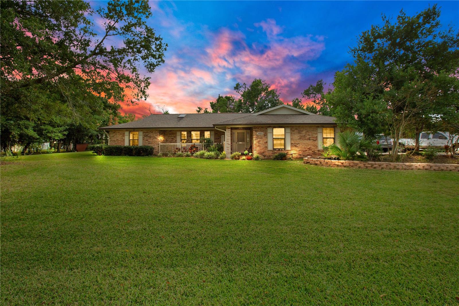 This is the one!! A timeless brick beauty with a charming front porch situated on a lusciously landscaped 163x123 double lot, fully updated & ideally located minutes to Deltona's Top Rated Golf Course, I-4, Shopping, Restaurants and Hospitals. This HUGE 3 bedroom 2 bath home with a formal living room, family room, and huge Florida room can easily be converted into a 4 bedroom or even 5 bedroom home! With almost 2300 square feet under air - the possibilities are limitless! Stunningly renovated inside & out included a New Roof (2016), HVAC (2017), Septic drain field (2017), Water Heater (2023), Screened porch (2016), Entire Home Water Softener & Filtration System (2017), Porcelain tile floors throughout (2021), Full kitchen remodel with high-end Stainless Steel appliances (2021), and Bathrooms remodeled this year!! WOW! This home is sure to check every single one of your boxes and then some! The fenced backyard with a huge storage shed is a gardener's dream! You will have mature banana trees, plantains, coffee plants, starfruit, avocado, orange, grapefruit, guava, kumquat, pigeon peas, pears, figs, passion fruit, and so much more! A home this incredible at a wonderful price is not one you want to sleep on! Schedule your showing ASAP and be prepared to fall in love!
