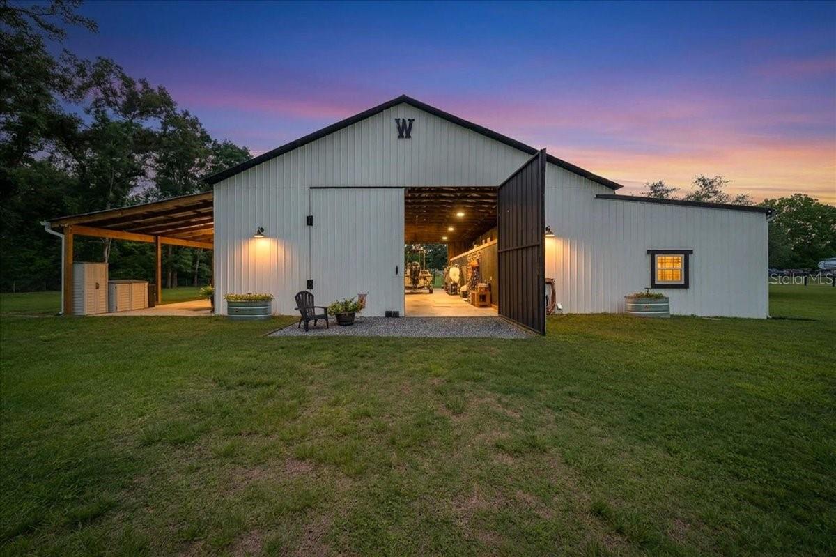 Exceptional 3-Acre Property on Ocala’s Desirable Northwest Side!

The care, craftsmanship, and attention to detail that have been invested into this remarkable 3-acre property are evident from the moment you arrive. Enter through the solar-powered gated entrance and immediately appreciate the thoughtful improvements throughout.

Pull right up to the oversized carport providing convenience and functionality before making your way to the impressive 30’ x 60’ barn. As the large sliding doors open, you’ll discover a massive 60’ x 31’ workshop space loaded with possibilities. Whether you’re looking for secure storage for boats, RVs, equipment, or vehicles, this versatile area is ready to accommodate your needs and already features a 50-amp RV hookup. For the equestrian enthusiast, this space could easily be transformed into an adorable horse barn complete with stalls, wash rack, grooming area, tack room, and more while still leaving plenty of room for storage and functionality.

Step inside the beautifully designed barn apartment and prepare to be impressed. The open-concept living space features a stunning kitchen complete with granite countertops, solid wood cabinetry, stainless steel appliances, and a spacious dedicated laundry room conveniently located just off the kitchen.

The dining area flows seamlessly into the family room, creating the perfect setting for entertaining family and friends. Custom double barn doors lead to the generous primary suite featuring a spacious bedroom, an impressive walk-in closet, and a beautifully appointed bathroom with an open tile shower. A private exterior door from the primary suite provides direct access to the cozy side porch, making it the perfect spot to enjoy peaceful mornings and breathtaking Florida sunsets.

Quality construction and upgrades throughout include:

• Beautiful laminate flooring*
• Faux wood Levolor blinds*
• Closed-cell spray foam insulation (4-inch exterior walls)*
• 50-gallon water heater*
• Carrier Hybrid central heat and air system*
• Spectrum Fiber Optic high-speed internet*
• Beadboard ceilings*
• 6-inch baseboards*
• New gutters, carport, and barn.*

Just outside, you’ll find an oversized covered back porch that functions like an expansive lanai, ideal for entertaining. Enjoy cookouts, gatherings, or movie nights with the custom outdoor TV cabinet already in place, along with two installed speakers—just add popcorn and enjoy!

As an added bonus, the property includes a completely remodeled 1-bedroom, 1-bath mobile home. Perfect for guests, extended family, or as a potential income-producing opportunity.

Additional property features include an outdoor shower, ideal for cooling off or bathing your four-legged family members, extra storage space in the well house, and mature fruit trees including grapefruit, lemon, and orange trees.

The entire 3-acre property is fully fenced with no-climb wire and top board fencing, providing security, functionality, and an attractive appearance.

"This one-of-a-kind property presents endless possibilities and must be seen in person to truly appreciate its many unique features".

Schedule your private showing today—this property is sure to make you smile!