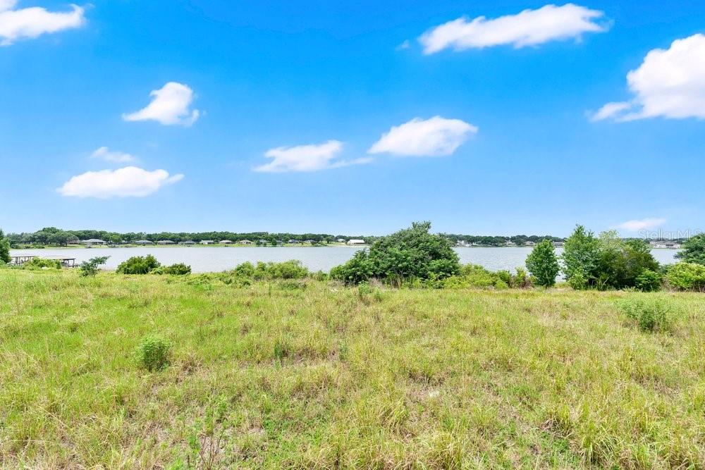 Discover the perfect setting to build your dream home on this beautiful waterfront vacant parcel located in Phase 2 of the highly sought-after Lake Juliana Estates in Auburndale. Nestled within this upscale gated community, this exceptional home-site offers serene water views and the opportunity to enjoy the very best of Florida lakefront living. Residents of Lake Juliana Estates enjoy resort-style amenities including a community clubhouse, fitness center, sparkling pool overlooking the lake, tennis and pickle-ball courts, basketball court, playground, private dock, and community boat ramp with access to Lake Juliana. Conveniently located just minutes from I-4, this prime location provides easy access to both Tampa and Orlando while maintaining the peaceful charm of lakeside living. Whether you envision a custom luxury retreat or your forever home, this rare waterfront opportunity offers the ideal blend of privacy, recreation, and convenience in one of Auburndale’s premier gated communities.