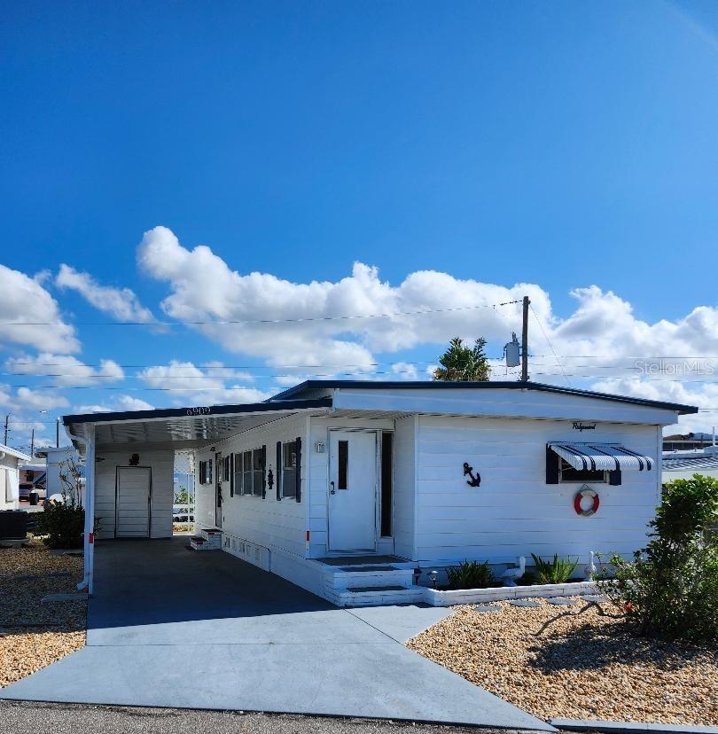 WALK TO EVERYTHING! An active resort lifestyle is just steps from your front door! Open and spacious Living and Dining areas in this 2 Bedroom, 1 1/2 Bath Mobile Home provide a bright, airy feel in the highly desired 55+ Trailer Estates waterfront community. Just a block to access the community pool, recreation buildings, shuffleboard, fitness center, and all the wonderful park amenities. New luxury vinyl plank floors throughout; new subfloors throughout. Master Bedroom has plenty of closets, built-in drawers and ensuite Half Bath. Laundry/utility shed with washer/dryer, has space for storage. A/C and ducting new 2024. You own the land. Boaters have direct access to Sarasota Bay from your doorstep, or the Trailer Estates Marina. Enjoy the large, heated community pool, hot tub, gym and wood shop. The community buzzes with pickleball, shuffleboard, kayaking, horseshoes, bocce, dancing and more. A US Post Office on site. 10 minutes to Sarasota-Bradenton Int'l Airport. Convenient to shopping, restaurants, the Arts and everything in Bradenton/Sarasota.