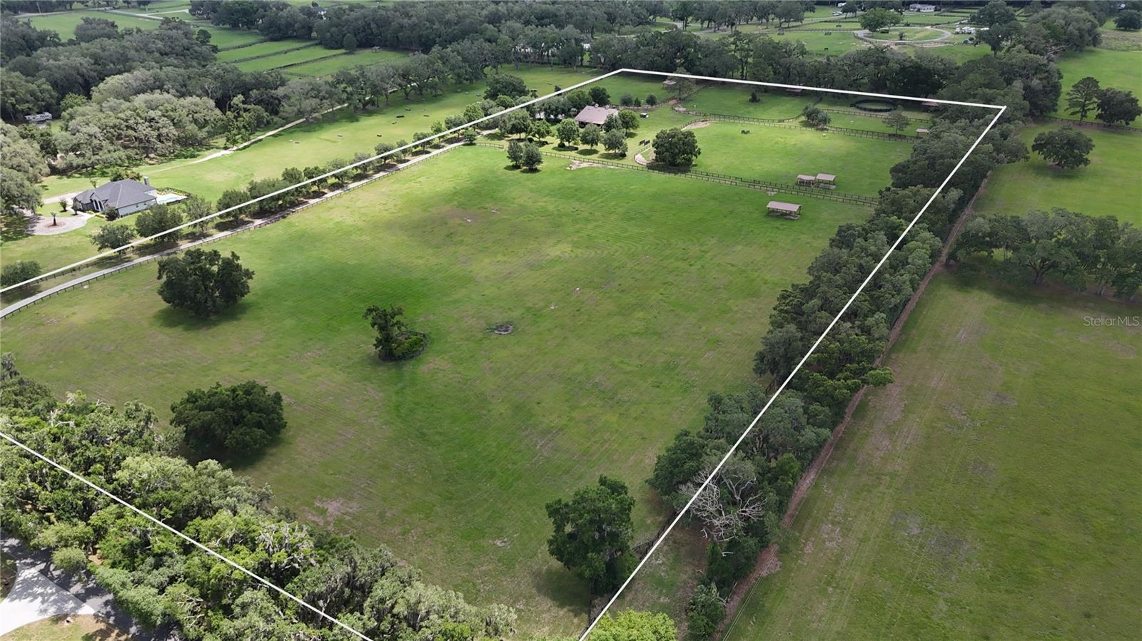 Perfectly positioned 20+/- acres off the highly desirable 225A corridor, this exceptional equestrian property offers a rare combination of quality construction, scenic views, and prime location.  Rolling pastures and long-range vistas set the tone as you arrive at this thoughtfully designed farm, ideal for both private use and professional operations.
The property features an 8-stall concrete block barn, complete with well-appointed living quarters, including a one-bedroom layout, open kitchen, and inviting living and dining areas.  A covered front porch overlooks the center aisle, perimeter fencing, and surrounding pastures, creating a picturesque and functional equestrian environment.  The barn also includes a generous side overhang, providing flexibility for equipment storage, additional work areas, or future expansion. 
The main residence is complemented by an attached three car garage.  Positioned on NW 80th Avenue, just minutes from Ocala's premier equestrian venues, this elevated farm delivers privacy, accessibility, and enduring value, an exceptional offering in one of the region's most sought-after equestrian corridors. 12 minutes from the World Equestrian Center and close to HITS.