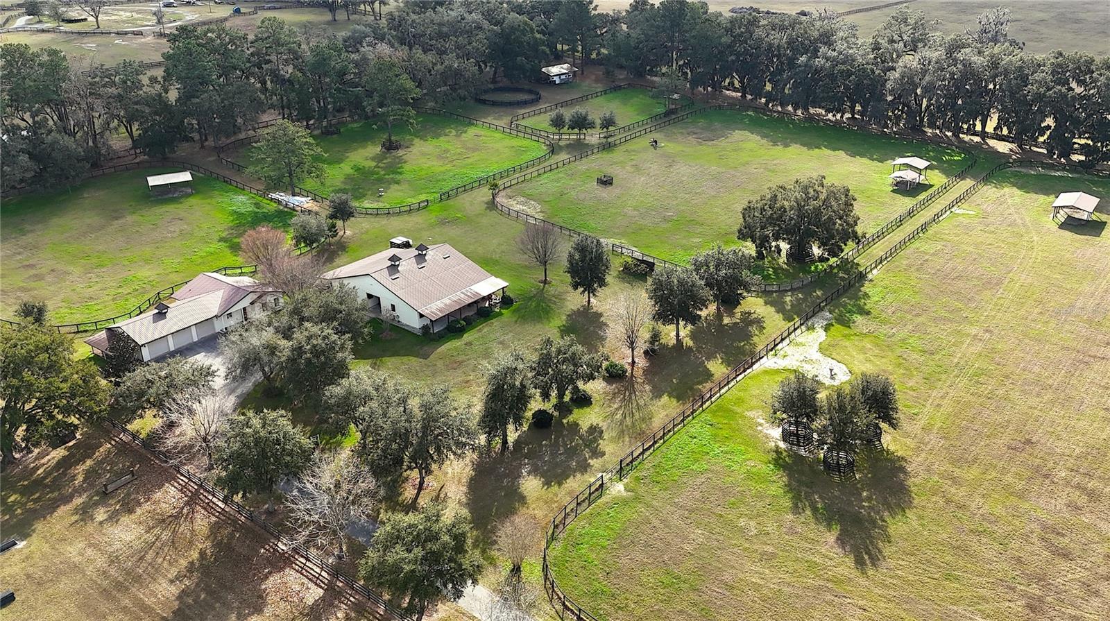 Perfectly positioned 20+/- acres off the highly desirable 225A corridor, this exceptional equestrian property offers a rare combination of quality construction, scenic views, and prime location.  Rolling pastures and long-range vistas set the tone as you arrive at this thoughtfully designed farm, ideal for both private use and professional operations.
The property features an 8-stall concrete block barn, complete with well-appointed living quarters, including a one-bedroom layout, open kitchen, and inviting living and dining areas.  A covered front porch overlooks the center aisle, perimeter fencing, and surrounding pastures, creating a picturesque and functional equestrian environment.  The barn also includes a generous side overhang, providing flexibility for equipment storage, additional work areas, or future expansion. 
The main residence is complemented by an attached three car garage.  Positioned on NW 80th Avenue, just minutes from Ocala's premier equestrian venues, this elevated farm delivers privacy, accessibility, and enduring value, an exceptional offering in one of the region's most sought-after equestrian corridors. 12 minutes from the World Equestrian Center and close to HITS.