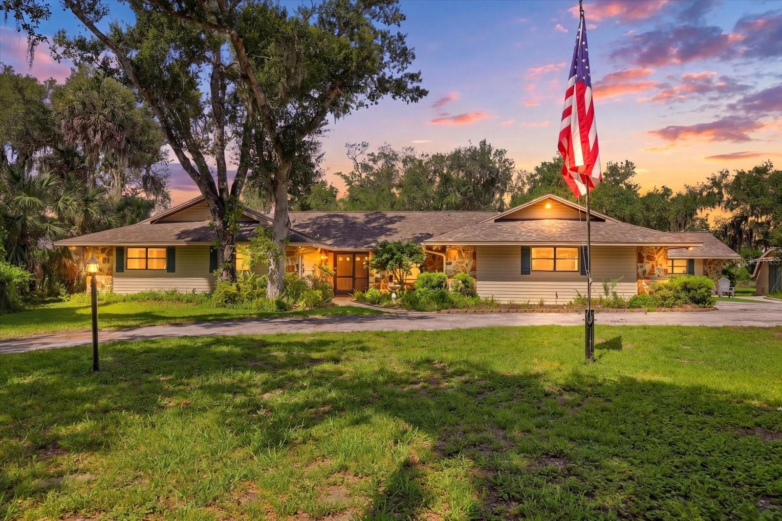 Welcome to 5850 Vanderipe Road, a spacious home set on 6.5 beautiful acres in the highly sought-after Myakka Valley Ranches community. Surrounded by gorgeous oak trees, peaceful views, and plenty of room for horses and animals, this property offers the privacy and space buyers are looking for with endless potential to make it their own. The home features 4 bedrooms, 3.5 bathrooms, 3,805 sq.ft. under air, an attached oversized 2-car garage, plus an additional detached 3-car garage and storage shed. Inside, you’ll find a generous floor plan with multiple living spaces, including a main family room with a wood-burning fireplace, an additional living room, separate dining room, and a large flex room on the north side of the home that could easily be used as a multi-generational suite, additional bedroom, office, game room, or guest retreat. The oversized primary suite offers excellent space and dual closets, while the home’s 3-zone air conditioning system provides added comfort throughout. Outdoors, enjoy tranquil Florida living from the covered and screened pool area, offering wonderful sun protection from the Florida heat while overlooking the tree-lined property, pond, dock, and peaceful sunset views. The private pond is ideal for fishing and adds to the serene country setting. Located in Unit 2 of Myakka Valley Ranches, this section has a voluntary HOA, and the community offers fiber optic internet, which is already wired to the home. Myakka Valley Ranches is known for its acreage homes, equestrian-friendly lifestyle, private roads, nature trails, and proximity to Myakka River State Park, top-rated schools, shopping, dining, and world-famous Siesta Key Beach. A rare opportunity to own a spacious home on a beautiful large-acreage property in one of Sarasota’s most desirable country communities.