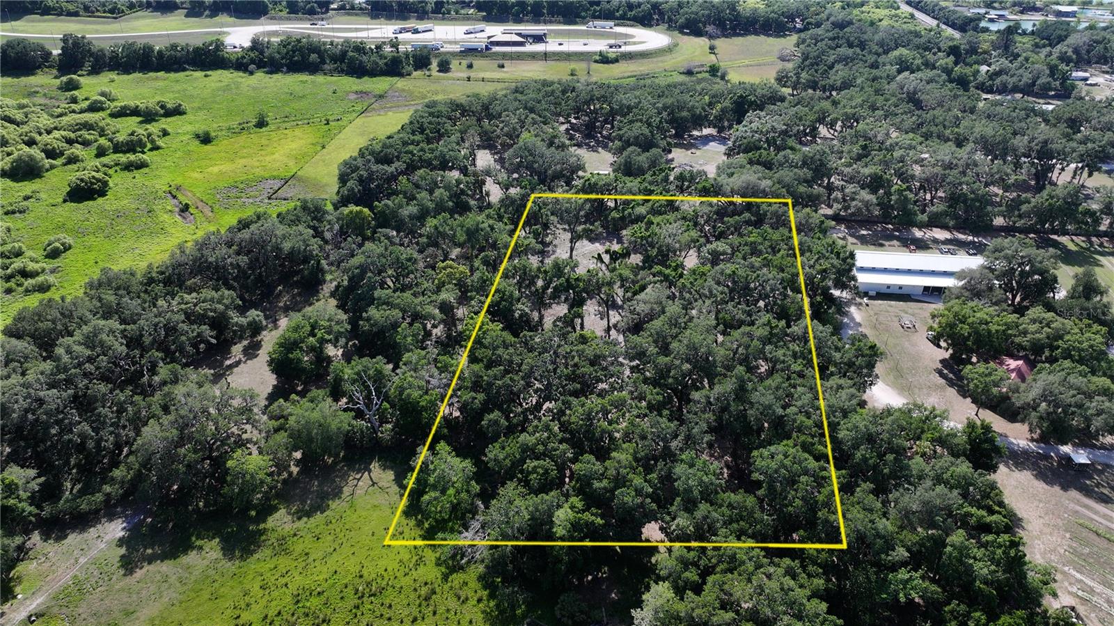 Discover the rare opportunity to create your own private estate on this beautiful 5-acre homesite with NO HOA, offering a peaceful blend of open space and natural Florida charm. A significant portion of the land is already cleared, providing an ideal foundation for your future build while still maintaining a sense of privacy, seclusion, and natural beauty.

Tucked away in a quiet rural setting, this property is designed for those seeking space, freedom, and a slower pace of life—without sacrificing convenience. Whether you envision a custom estate home, equestrian retreat, hobby farm, or small business setup, the possibilities are wide open.

Mature citrus trees—including orange, grapefruit, and tangerine—add character and a touch of Florida living, creating a warm and established feel from the moment you arrive.

With no close neighbors and a serene natural backdrop, this property offers the kind of peace and privacy that is becoming harder to find. Build your vision from the ground up and design a lifestyle rooted in space, nature, and independence.

Buildable. Private. Versatile. Rare.

By appointment only.