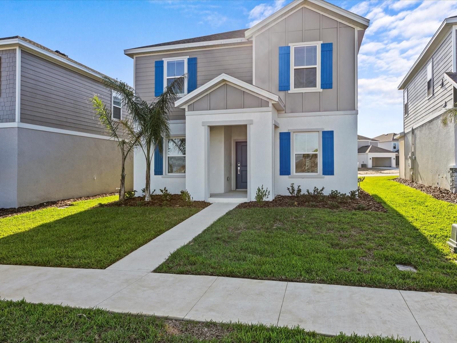 This 5-bedroom, 3-bath, roughly 2500 square-foot Delray by Lennar is available for rent in Wellness Ridge, a master-planned community in Clermont. The versatile two-story floor plan is designed for modern family living and multigenerational flexibility. The first floor offers an open-concept layout connecting the kitchen, dining, and great room, anchored by a kitchen with quartz countertops, a walk-in pantry, and abundant cabinet storage. A main-floor bedroom with an adjacent full bath accommodates guests, extended family, or a private home office, while a separate flex space adapts to a study, playroom, or remote-work setup. Upstairs, the primary suite functions as a private retreat with a tray ceiling, an oversized walk-in closet, and an en-suite bath featuring a walk-in shower and a separate soaking tub. Three additional bedrooms offer generous proportions, and a dedicated second-floor laundry room adds everyday convenience near the sleeping quarters. Residents of Wellness Ridge enjoy access to the community's newly completed clubhouse and amenities for recreation, fitness, and gathering. Located 10–15 minutes from Clermont's grocery stores, dining, and weekend farmers markets, with convenient access to State Road 50, Florida's Turnpike, and the greater Central Florida corridor. Available for at least a 12-month lease. All appliances included. Rent covers landscaping and 1 GB high-speed internet, simplifying move-in and monthly budgeting.