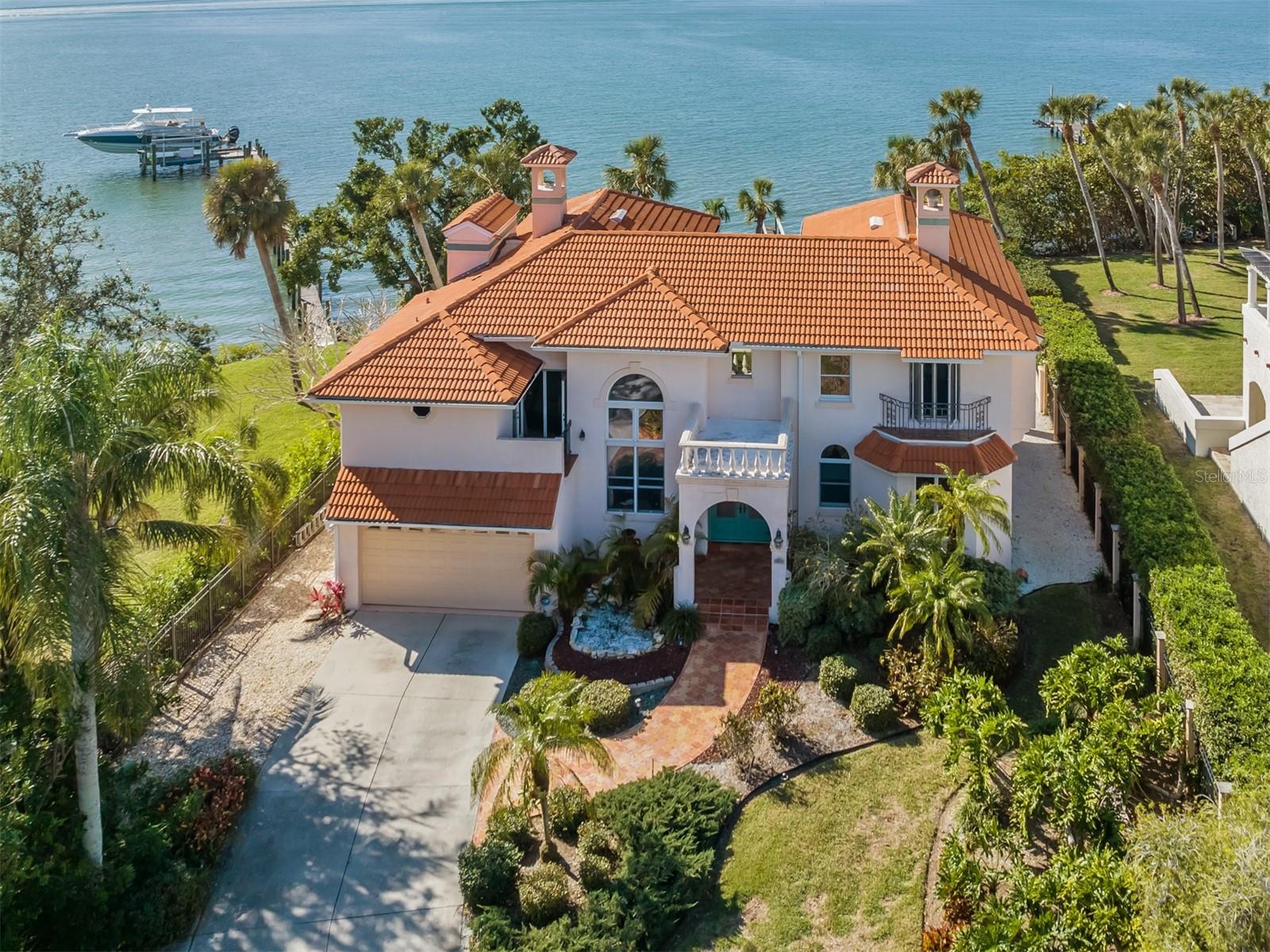 This is truly paradise! Highly sought after and very hard to find! All on this picturesque homesite on Blackburn Bay! There is a main house and guesthouse on this property and the opportunities are endless. The main house has three bedrooms, three bathrooms, separate office with built-ins, wet bar, fireplace, separate fitness room off the master suite all while capturing the beautiful bay views and sunsets on the balconies. Family room is spacious and has beautiful bay breezes as you sit by the fireplace on those cozy evenings at home. The spacious kitchen with breakfast nook is ready for all of your entertaining needs. Formal dining room offers volume ceilings and plenty of seating for everyone to enjoy. You will enjoy the large lanai, cocktail pool and garden area off the kitchen. The guesthouse has two bedrooms and two bathrooms with over 1,300 square feet of living space and ample parking for the guest and main house with plenty of room to store your toys. You can have your family close by for those quick trips or a great income opportunity. This estate offers plenty of room for everyone with a combined air-conditioned space of over 4,600 square feet. The property is a private tropical paradise with a park-like setting. This home is truly a must-see and is in an exceptional location close to gorgeous beaches, shopping, dining, the new Sarasota Memorial Hospital, A-rated schools as well as Pine View School, Interstate 75 and so much more. This home has so much to offer and the location can't be beat. Schedule your private showing today because this home will not last long.
