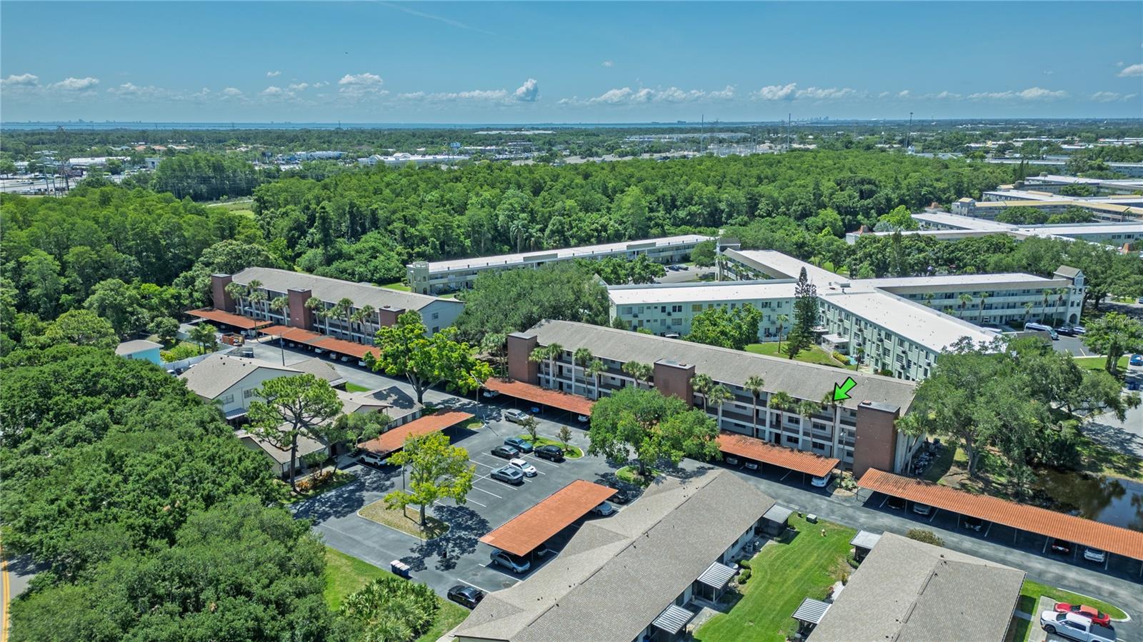 Located in the desirable Villas at Countryside community in Clearwater, this pet friendly condo puts you just steps from the heated community pool and clubhouse while keeping you close to some of the area’s best beaches, parks, shopping, and dining. Set in the heart of Countryside, the community offers an all ages setting with low HOA fees, assigned covered parking, guest parking, elevator access, shuffleboard courts, and proximity to Woodgate Park. Honeymoon Island State Park is approximately 10 miles away, with Clearwater Beach, Dunedin, Safety Harbor, Countryside Mall, US 19, Tampa International Airport, and St. Pete Clearwater Airport also within easy reach. Inside, the unit features a bright and functional layout with warm wood look flooring, neutral finishes, ceiling fans, and an easy flow between the living, dining, and kitchen areas. Large windows and sliding glass doors bring in natural light, helping the home feel open and welcoming. The kitchen offers plenty of cabinet storage, a double sink, pantry style storage, and a practical layout for everyday use, while inside laundry adds an important everyday convenience. The enclosed balcony is one of the standout features, adding approximately 130 bonus square feet of usable space that can be enjoyed as a sitting area, reading nook, morning coffee spot, or flexible bonus area. The bedroom offers direct access to the enclosed balcony, creating a nice extension of the living space, and the balcony also includes extra storage for added convenience. Whether you are looking for a full time residence, seasonal getaway, or low maintenance Clearwater retreat, this condo offers a great combination of location, amenities, value, and Florida lifestyle appeal.