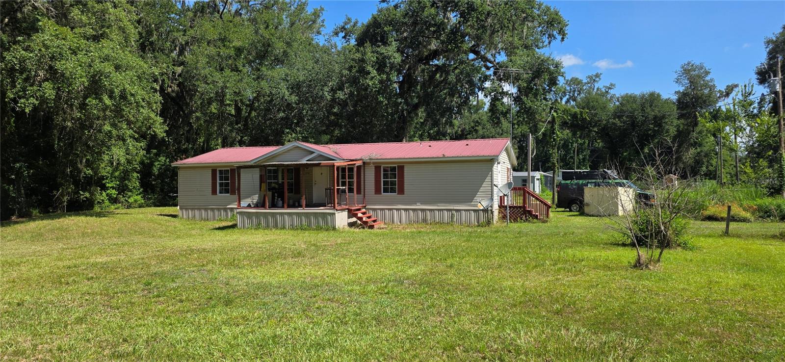 CASH ONLY! Escape to peaceful country living with this 3-bedroom, 2-bath manufactured home on a spacious 0.38-acre corner lot in Webster! Nestled among beautiful mature oak trees, this 1,344-square-foot home offers the perfect blend of privacy, comfort, and convenience with easy access to Bushnell, I-75, and everything Central Florida has to offer. Inside, you'll find a functional split-bedroom floor plan featuring a spacious great room, a second living area, tile flooring throughout the main living spaces, and an inside laundry room. The open kitchen overlooks the living area, making it ideal for everyday living and entertaining. Enjoy your morning coffee on the large covered front porch while taking in the peaceful rural setting. Outside, the fenced yard provides plenty of room for pets, gardening, or outdoor activities. A storage shed offers additional space for tools and equipment, while the well house helps protect your well system. Major updates include a 2014 HVAC system and a durable 2007 metal roof, providing added peace of mind. Located in Flood Zone X, this home sits on a paved road and offers the freedom and tranquility of country living without sacrificing accessibility. Whether you're searching for a primary residence, seasonal getaway, or investment opportunity, this affordable property is ready for its next owner. Schedule your private showing today and experience the charm of rural Florida living!