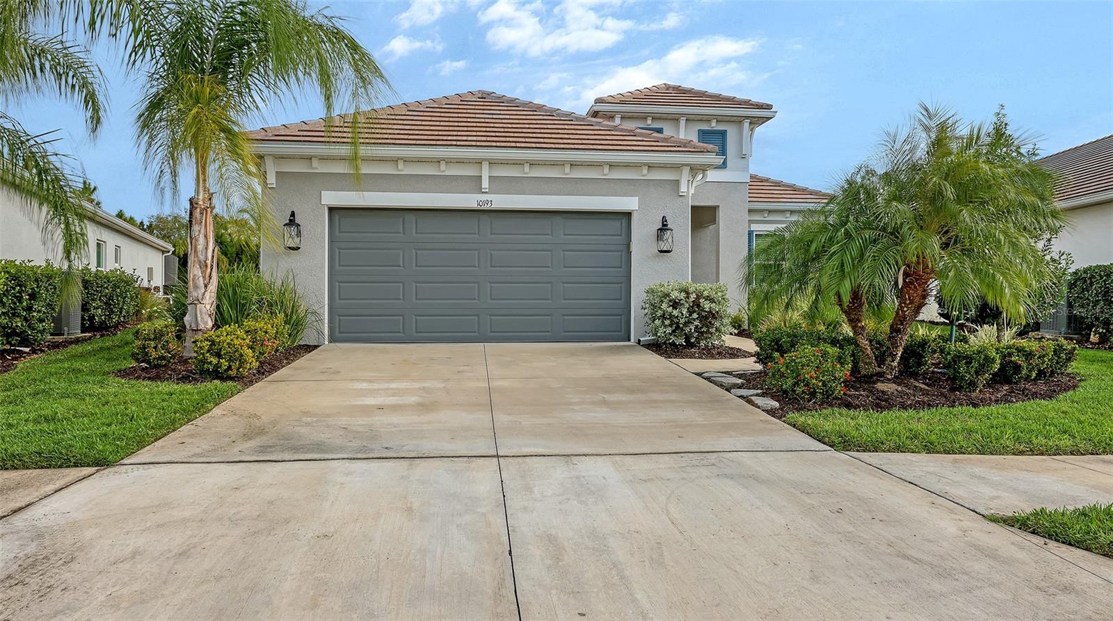 $10,000 price improvement! Better than new in Grand Park! A highly upgraded White Star floor plan by Neal Communities is ready for the most discerning buyers. It provides 2,064 sq. ft of luxury finishes, privacy and well thought out functionality in a light-filled open floor plan. Impact glass windows, hurricane shutters for the sliders and a ring doorbell add the security you are looking for. A whole-house water filtration and water softening system have been added.  A large, screened lanai with custom pet door leads to the wrought iron fenced private yard. Inside, you’ll find elegant silver/crystal contemporary light fixtures, whitewash ceramic wood-look plank flooring throughout, neutral paint color, four ceiling fans with lights, and tray ceilings in the foyer, great room and primary bedroom. The chef’s kitchen includes a large quartz covered island with pendant lighting and breakfast bar, white linen 36” upper cabinets with crown molding, quartz counter tops, soft close doors and drawers, under-cabinet lighting, and tile backsplash. The stainless appliances include a gas stove (preferred by chefs), French-door refrigerator, dishwasher and microwave. Add to that a butler’s pantry to keep the chef organized and you’re ready to entertain in style! The primary bedroom is located in the rear of the house for privacy and includes two walk-in closets and an ensuite bathroom.  A handheld shower head and heated bidet toilet seat add a touch of luxury. The guest bedrooms are in the front of the house with a guest bath with tub between them.  A spacious den/office with double doors and a laundry room featuring an LG steam turbo washer/dryer with laundry sink complete the picture. The garage has an insulated garage door plus attic access with additional insulation and aluminum stairs/ladder. Grand Park is an amenity-rich community. The amenity center has two resort-style pools, fitness center, clubhouse, pickle ball and tennis courts, playground and dog park. Grand Park is conveniently located just East of I-75 and a short distance to Siesta Key Beach and downtown Sarasota with its arts venues and multiple restaurants.