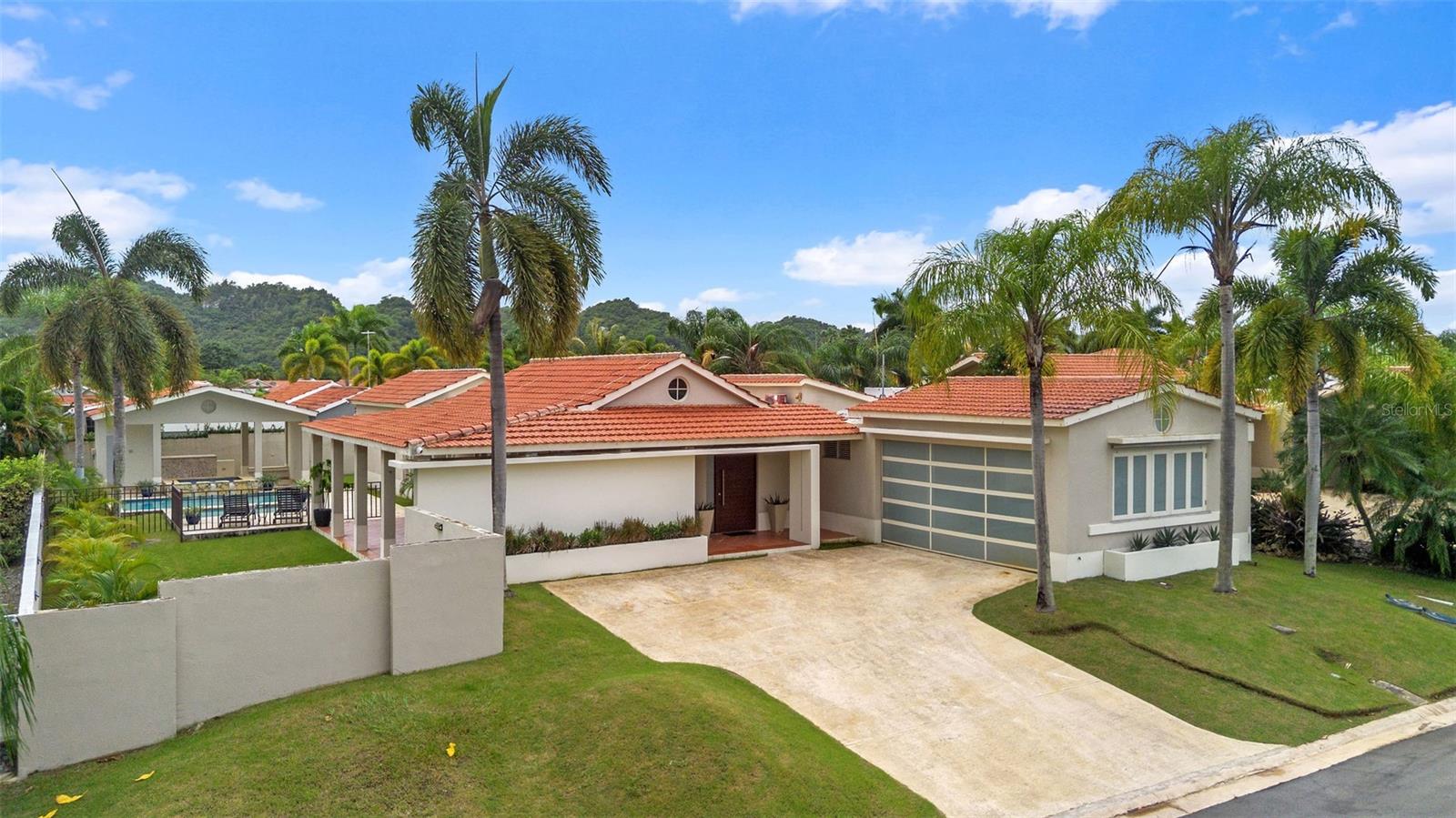 Discover Residence 170 at Camino Los Jazmines, a beautifully upgraded and move-in–ready single-level home located in the exclusive gated community of Sabanera Dorado. Set on a 927.5 m² lot, this residence offers elegance, comfort, and high-end functionality within one of the most desirable family communities in Puerto Rico.

Featuring 4 bedrooms, 3 full bathrooms, and 2 half bathrooms, the home provides spacious living areas with abundant natural light and a thoughtfully designed layout. The residence includes a fully equipped kitchen and a fully equipped laundry room, both offering turnkey convenience from day one.

Offers exceptional outdoor and lifestyle amenities, including a welcoming terrace, a gazebo with a full BBQ area, and an attached 2-car garage for added convenience. A 4-seater golf cart is also included, providing easy access throughout the Sabanera community.

For power and water reliability, the home is equipped with a 15 kW generator, 500-gallon water cistern, water softener system, and a solar panel system paired with a Tesla Powerwall 3. A Tesla Universal Charger is also installed, adding modern efficiency and sustainability to the property.

This exceptional residence combines privacy, comfort, and resort-style living. Just minutes from top community amenities—including The TASIS School, trails, lakes, gyms, pools, and sports facilities—Sabanera Dorado continues to be one of the island’s most sought-after communities for families.